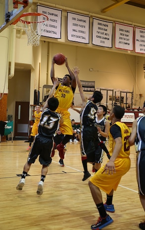 Jarell Davis, a senior with Matthew C. Perry High School Samurai basketball team, shoots to score during a game against the Tabuse Agricultural-Technical High School basketball team on Jan. 18, 2015 at the high school gymnasium aboard Marine Corps Air Station Iwakuni, Japan. The Samurai won the game against their Japanese counterparts with a score of 57-29 and continue to dominate this season with an undefeated streak of 11-0.