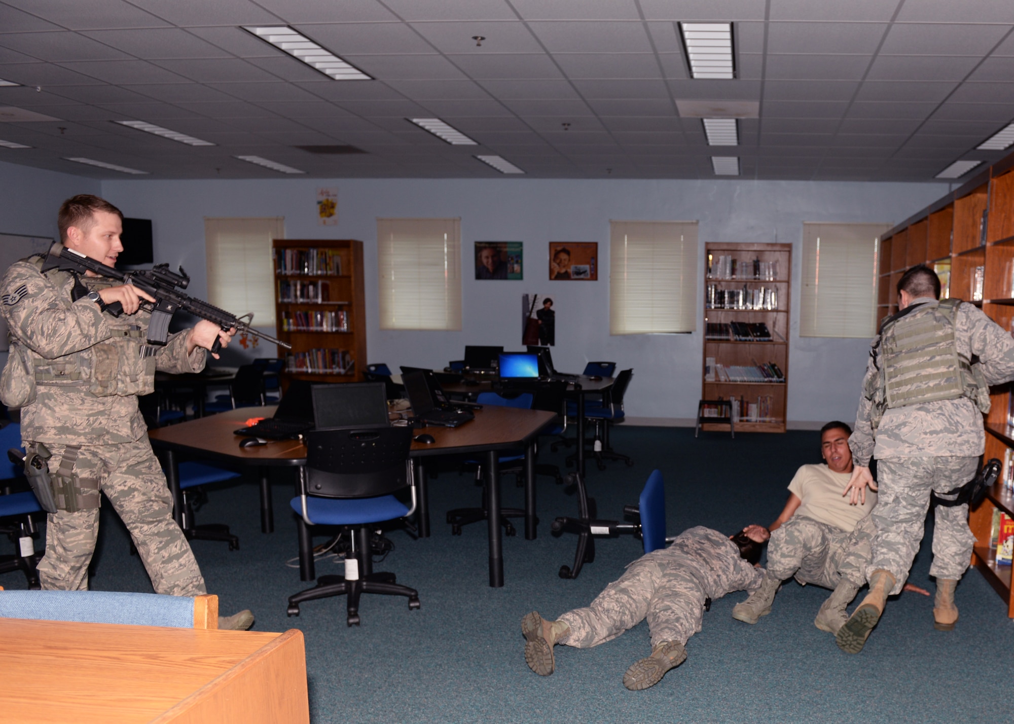 36th Security Forces Squadron Airmen take control of a hostage situation during active shooter training at Andersen Middle school Jan. 18, 2015, at Andersen Air Force Base, Guam. The training is designed to familiarize SFS Airmen with the school and to fine -tune their tactics in the event a real situation occurs.(U.S. Air Force photo by Senior Airman Cierra Presentado/Released)


