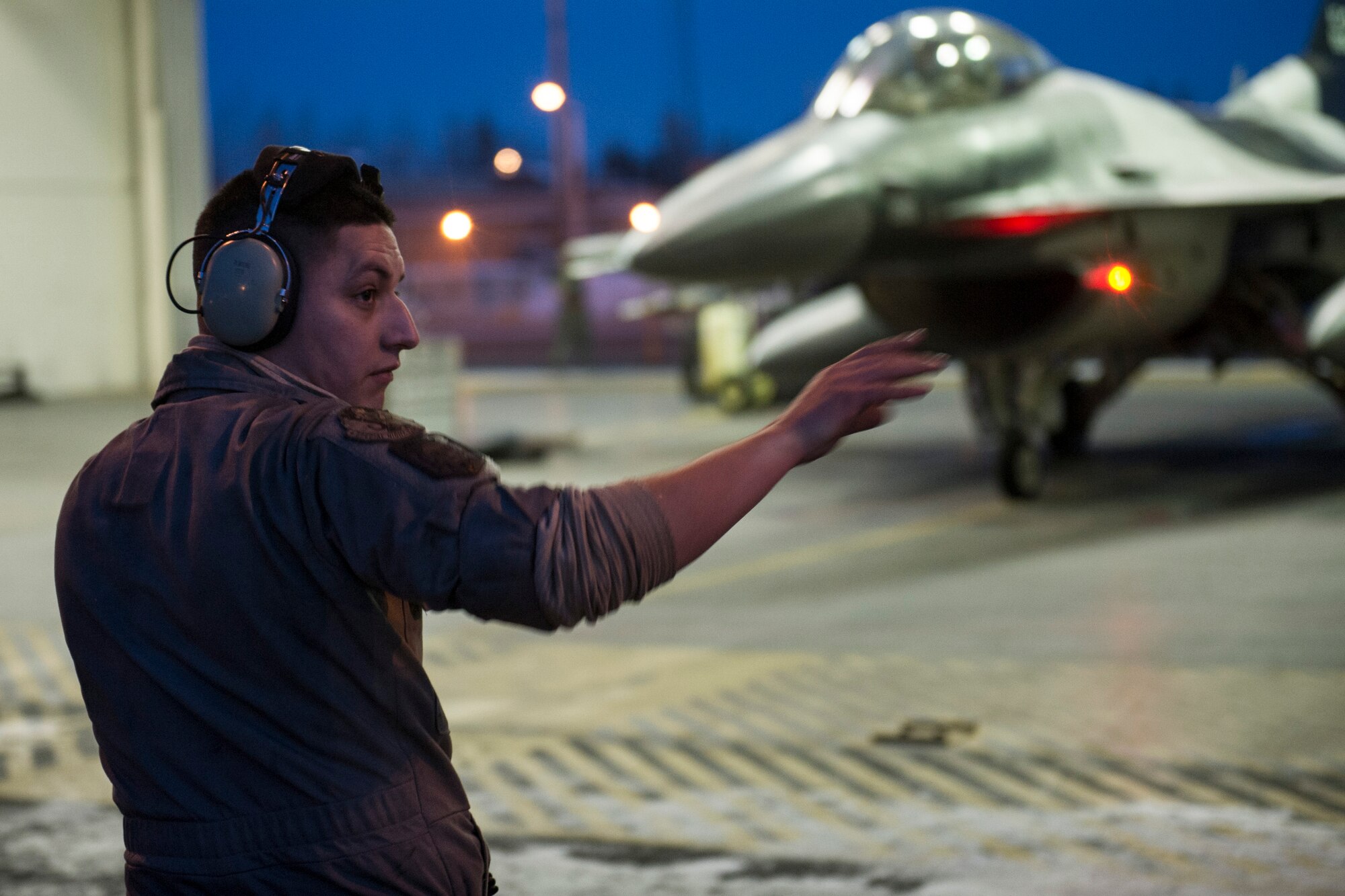 U.S. Air Force Senior Airman Nathaniel Moore, a crew chief assigned to the 354th Aircraft Maintenance Squadron, prepares to launch an F-16 Fighting Falcon aircraft on Eielson Air Force Base, Alaska, Jan. 17, 2015, for travel to Joint Base Pearl Harbor-Hickam, Hawaii, and Andersen Air Force Base, Guam.  More than 150 maintainers will keep the 18th Aggressor Squadron in the air during Pacific Air Forces exercises, which are meant to prepare U.S. Airmen, Sailors and Marines along with coalition partners in the Pacific theater of operations for contingency operations if the need arises. (U.S. Air Force photo by Staff Sgt. Joshua Turner/Released)