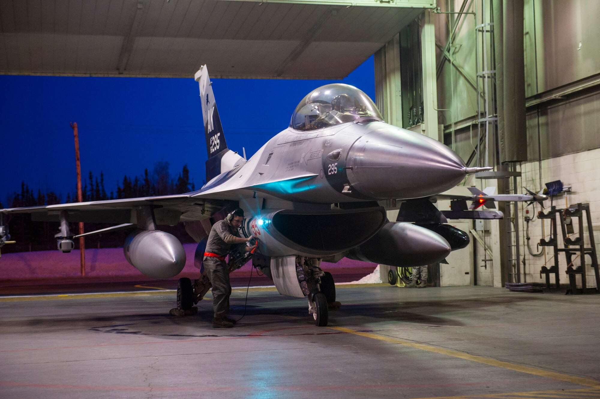 U.S. Air Force Senior Airman Nathaniel Moore, a crew chief assigned to the 354th Aircraft Maintenance Squadron, prepares an F-16 Fighting Falcon aircraft on Eielson Air Force Base, Alaska, Jan. 17, 2015, for travel to Joint Base Pearl Harbor-Hickam, Hawaii, and Andersen Air Force Base, Guam.  More than 150 maintainers will keep the 18th Aggressor Squadron in the air during Pacific Air Forces exercises, which are meant to prepare U.S. Airmen, Sailors and Marines along with coalition partners in the Pacific theater of operations for contingency operations if the need arises. (U.S. Air Force photo by Staff Sgt. Joshua Turner/Released)