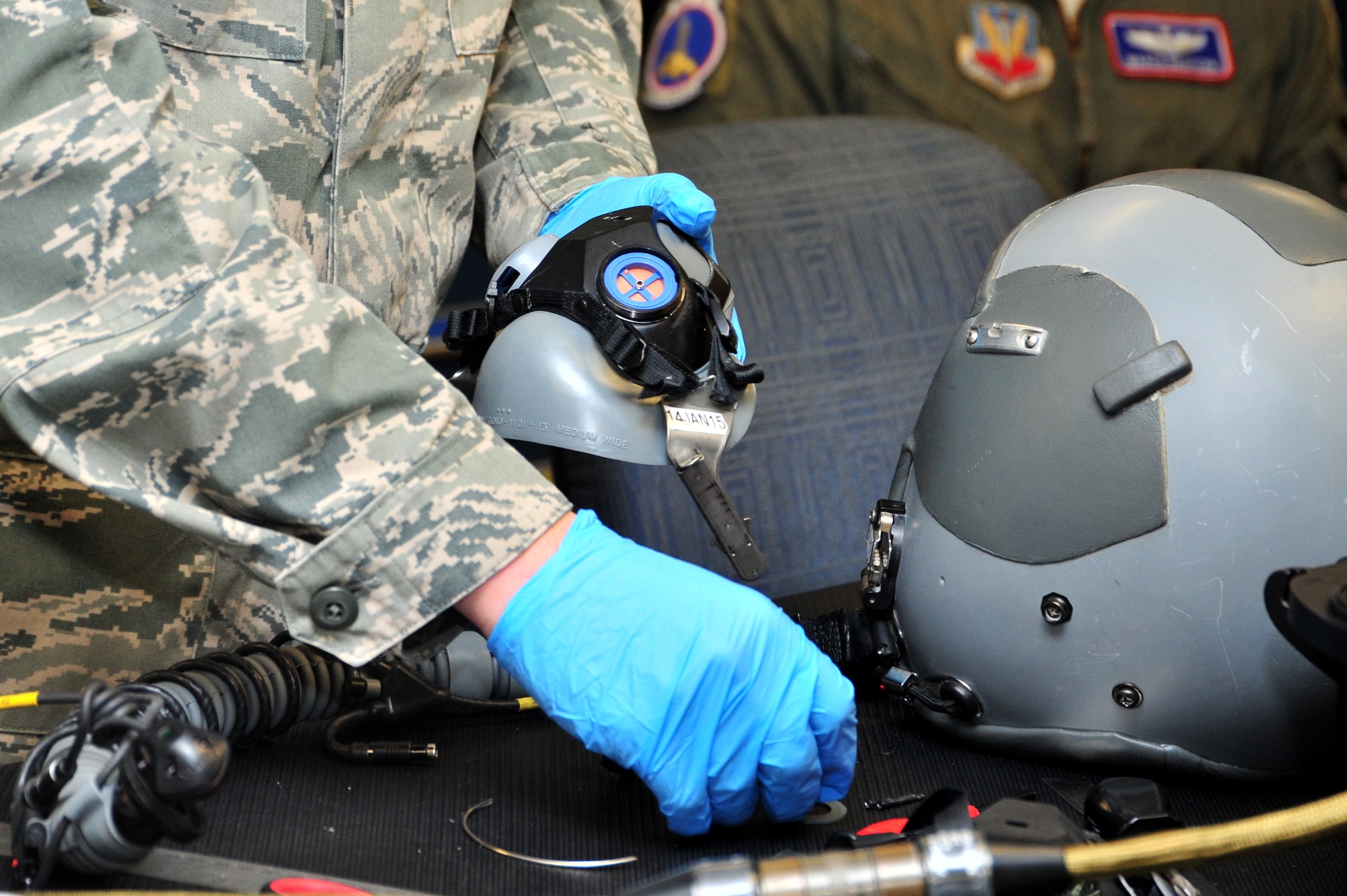 U.S. Air Force Airman 1st Class Joseph Gago, 355th Operations Support Squadron Aircrew Flight Equipment technician, makes modifications to an A-10C Thunderbolt II helmet at Davis-Monthan Air Force Base, Ariz., Jan. 8, 2014.  The helmets were modified to fit a new helmet mounted integrated targeting system. (U.S. Air Force photo by Airman 1st Class Chris Massey/Released)