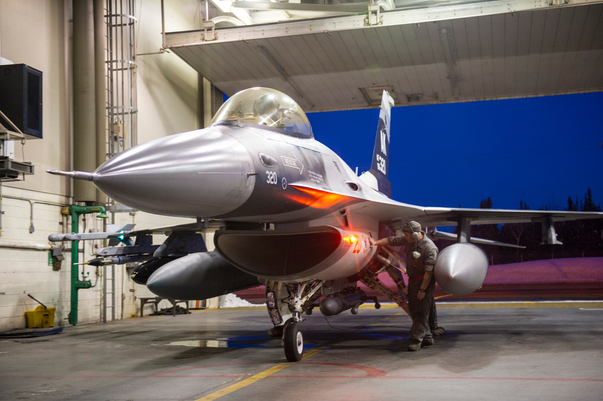 U.S. Air Force Tech. Sgt. Shane Morris, a crew chief assigned to the 354th Aircraft Maintenance Squadron, prepares an F-16 Fighting Falcon aircraft on Eielson Air Force Base, Alaska, Jan. 17, 2015, for travel to Joint Base Pearl Harbor-Hickam, Hawaii, and Andersen Air Force Base, Guam.  More than 150 maintainers will keep the 18th Aggressor Squadron in the air during Pacific Air Forces exercises, which are meant to prepare U.S. Airmen, Sailors and Marines along with coalition partners in the Pacific theater of operations for contingency operations if the need arises. (U.S. Air Force photo by Staff Sgt. Joshua Turner/Released)
