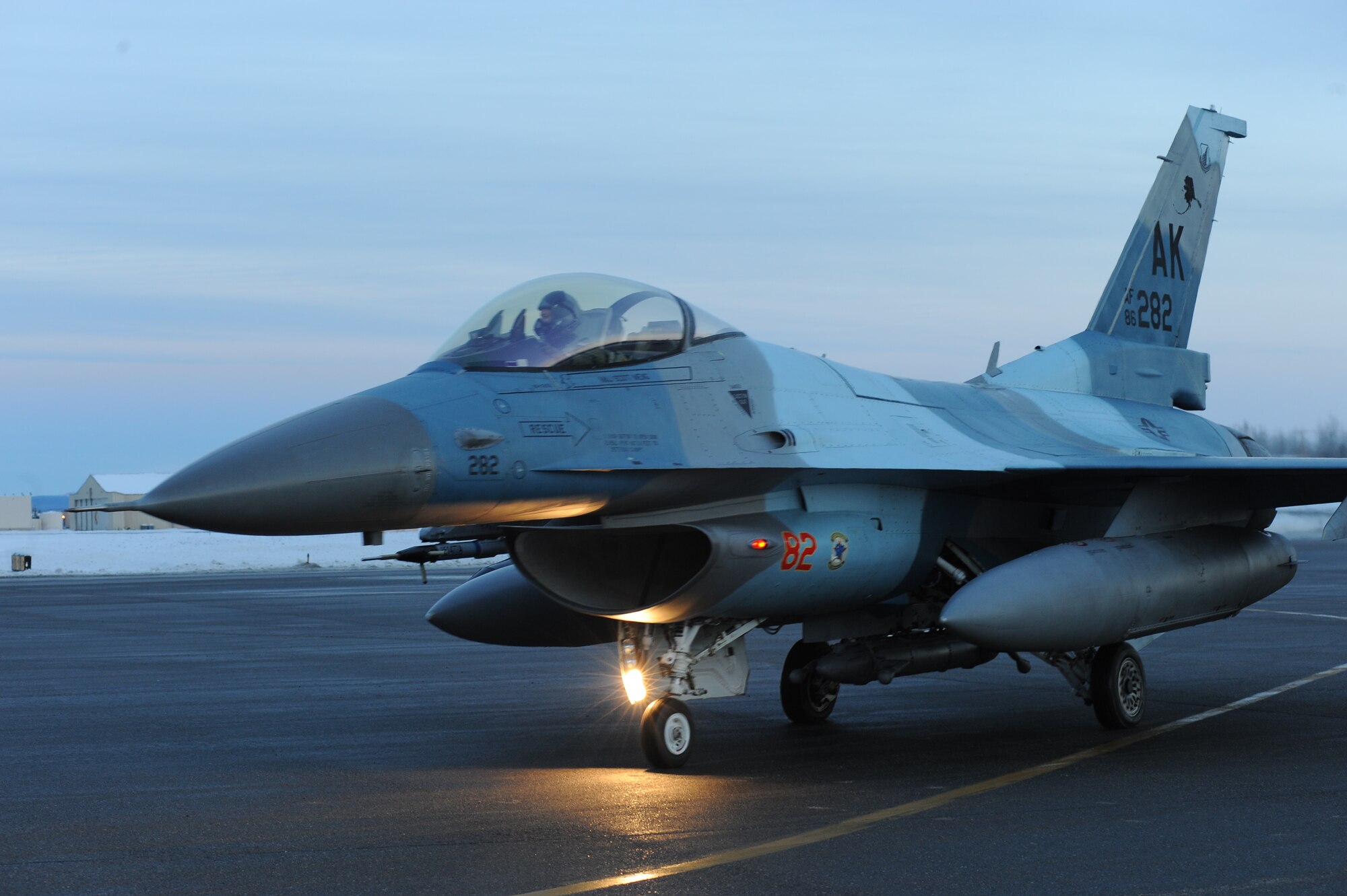 A U.S. Air Force F-16 Fighting Falcon pilot assigned to the 18th Aggressor Squadron prepares to take-off from Eielson Air Force Base, Alaska, Jan. 17, 2015. The jets are in transit to Joint Base Pearl Harbor-Hickam, Hawaii, and Andersen Air Force Base, Guam, to participate in Pacific Air Forces exercises. More than 150 maintenance Airmen will keep the Aggressors in the air during the exercises which are meant to prepare U.S. Airmen, Sailors and Marines along with coalition partners in the Pacific theater of operations for contingency operations if the need arises. (U.S. Air Force photo by Staff Sgt. Kirsten Wicker/Released)