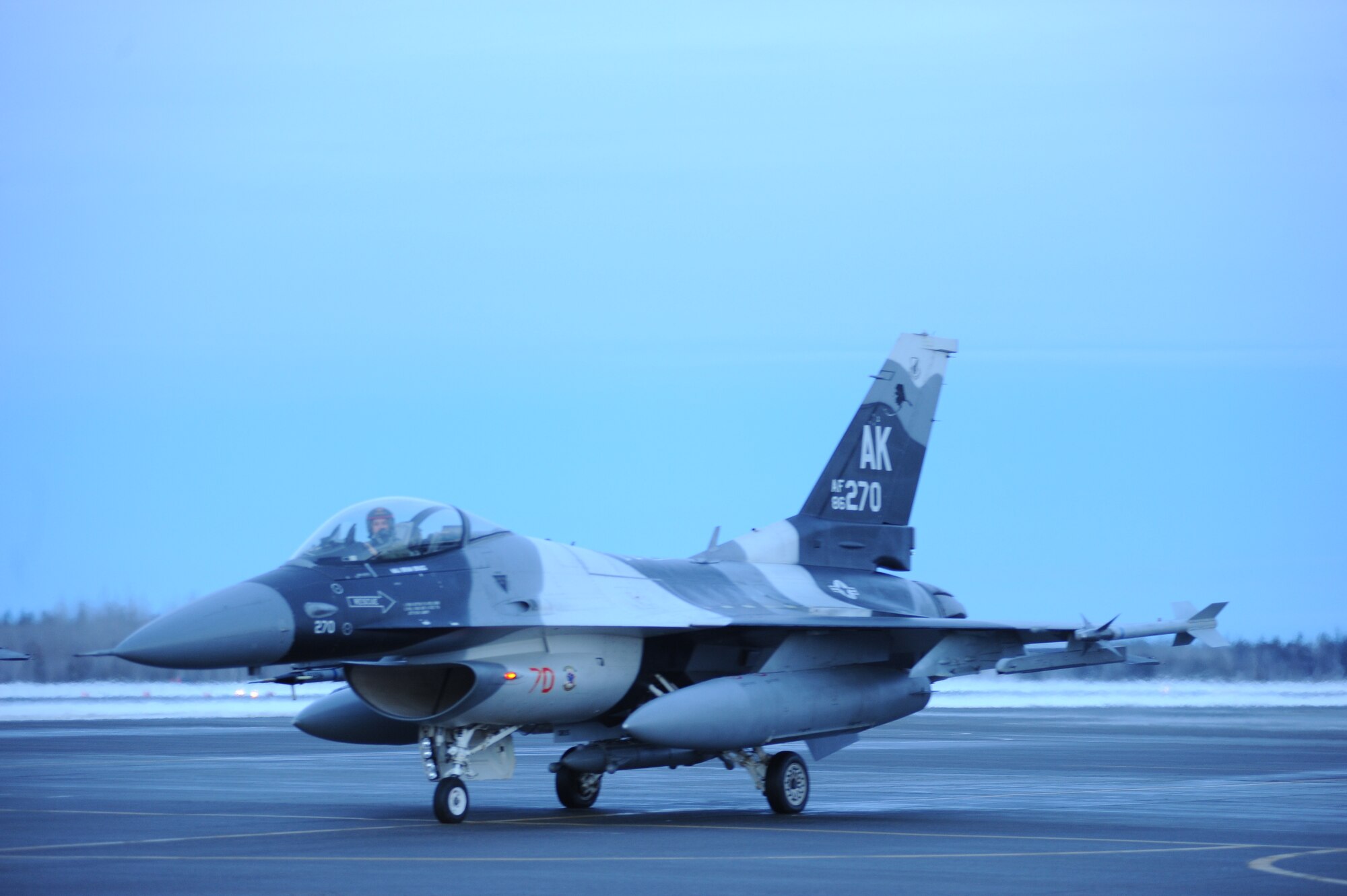 A U.S. Air Force F-16 Fighting Falcon pilot assigned to the 18th Aggressor Squadron prepares to take-off from Eielson Air Force Base, Alaska, Jan. 17, 2015. The jets are in transit to Joint Base Pearl Harbor-Hickam, Hawaii, and Andersen Air Force Base, Guam, to participate in Pacific Air Forces exercises. More than 150 maintenance Airmen will keep the Aggressors in the air during the exercises which are meant to prepare U.S. Airmen, Sailors and Marines along with coalition partners in the Pacific theater of operations for contingency operations if the need arises. (U.S. Air Force photo by Staff Sgt. Kirsten Wicker/Released)