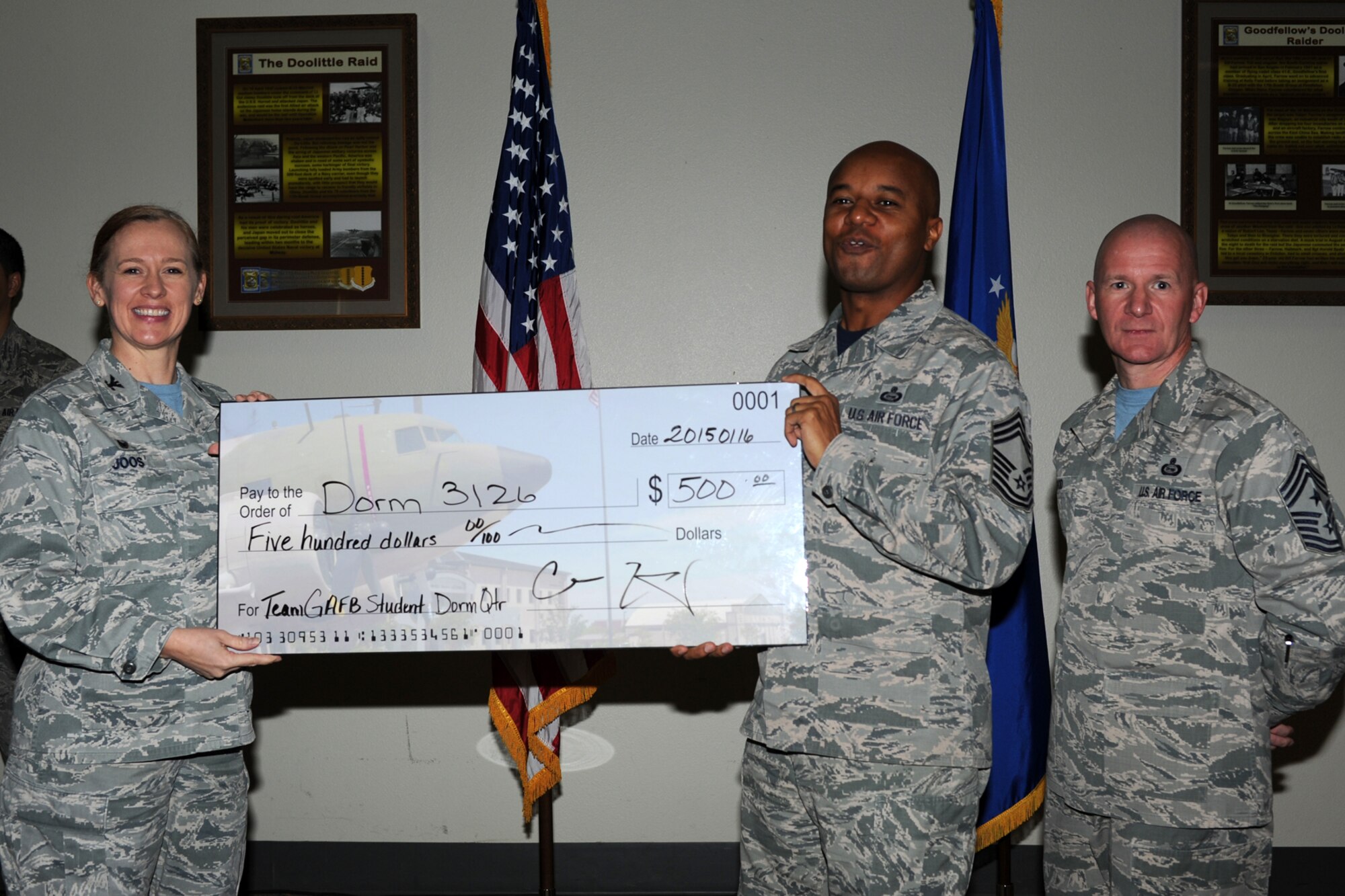 GOODFELLOW AIR FORCE BASE, Texas - Col. Kimberlee P. Joos, 17th Training Wing Commander, and Chief Master Sgt. Thomas F. Good, 17th TRW Command Chief, present Chief Master Sgt. Marcus A. Hall, 315th Training Squadron superintendent, with the Team Goodfellow Student Dormitory of the Quarter award during the wing quarterly awards ceremony at the Event Center Jan. 16. (U.S. Air Force photo/ Staff Sgt. Laura R. McFarlane)