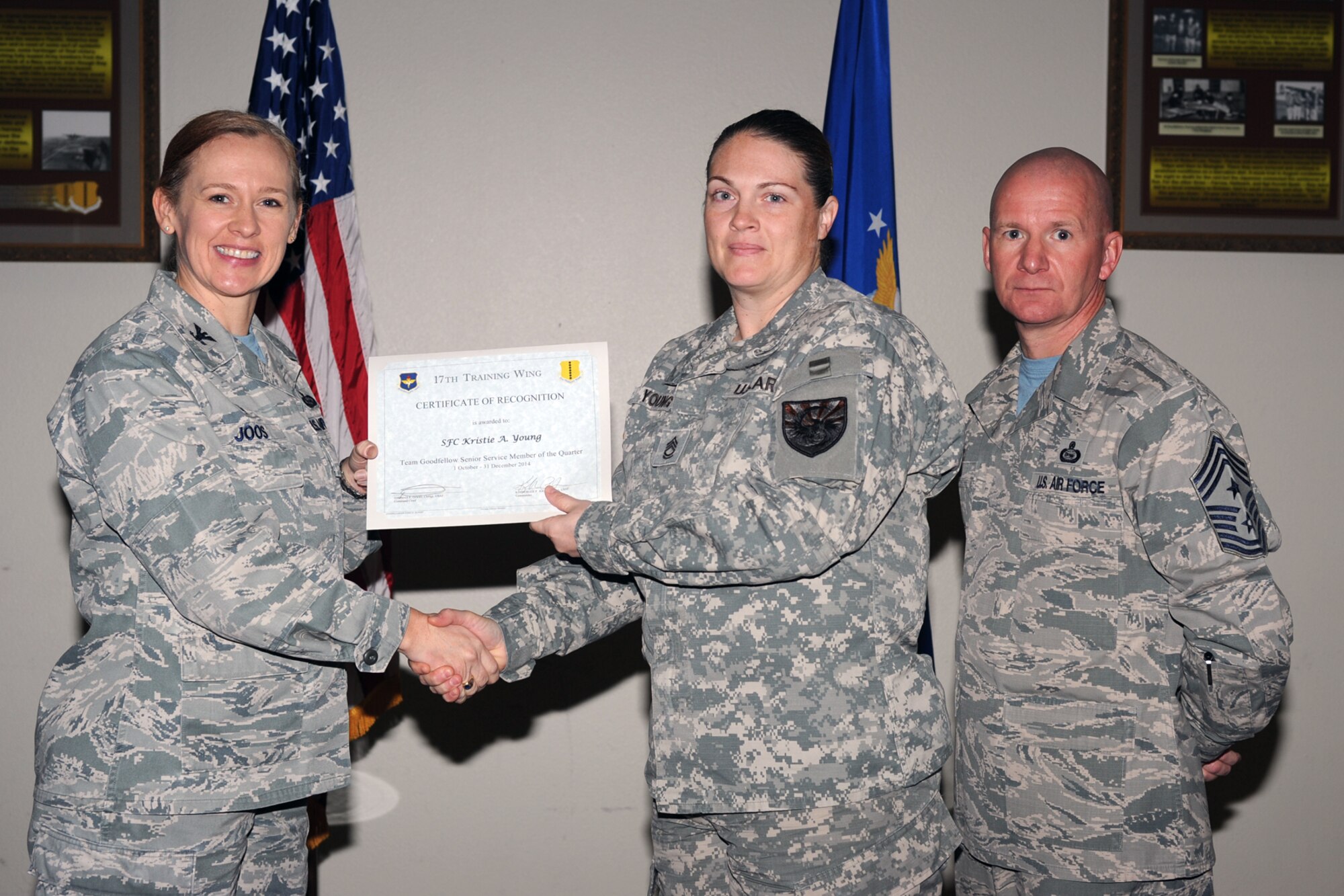 GOODFELLOW AIR FORCE BASE, Texas - Col. Kimberlee P. Joos, 17th Training Wing Commander, and Chief Master Sgt. Thomas F. Good, 17th TRW Command Chief, present the Team Goodfellow Senior Service Member of the Quarter award to Army Sgt. 1st Class Kristie A. Young, 344th Military Intelligence Battalion, during the wing quarterly awards ceremony at the Event Center Jan. 16. (U.S. Air Force photo/ Staff Sgt. Laura R. McFarlane)