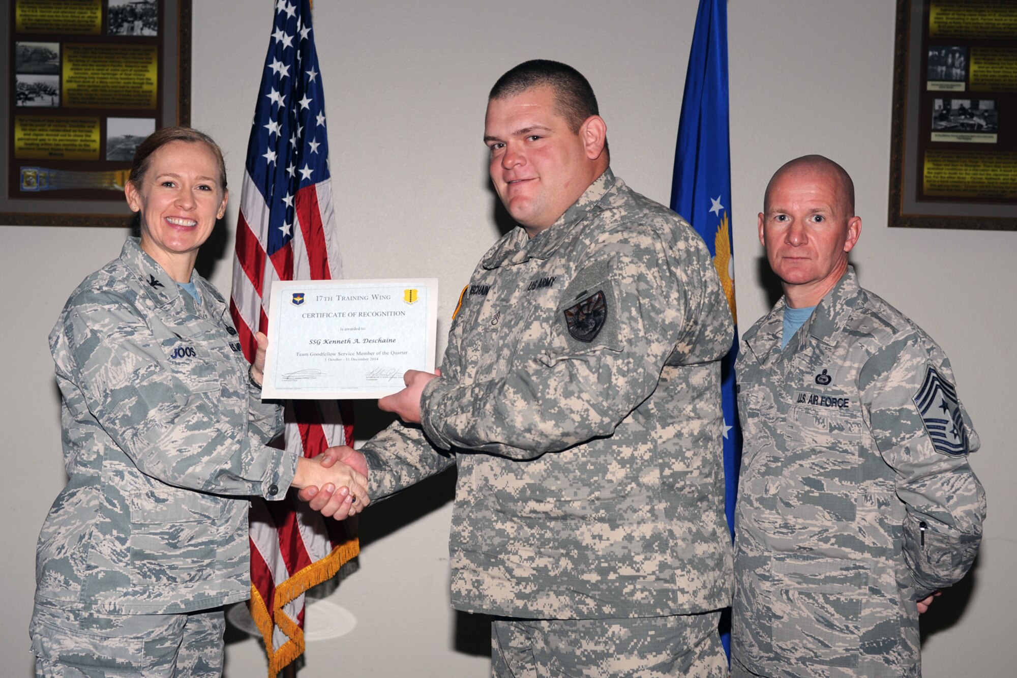 GOODFELLOW AIR FORCE BASE, Texas - Col. Kimberlee P. Joos, 17th Training Wing Commander, and Chief Master Sgt. Thomas F. Good, 17th TRW Command Chief, present the Team Goodfellow Service Member of the Quarter award to Army Staff Sgt. Kenneth A. Deschaine, 344th Military Intelligence Battalion, during the wing quarterly awards ceremony at the Event Center Jan. 16. (U.S. Air Force photo/ Staff Sgt. Laura R. McFarlane)