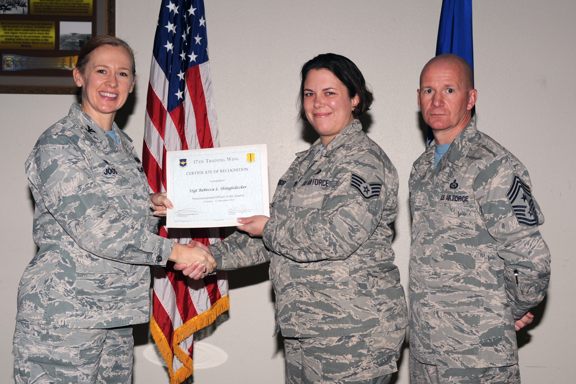 GOODFELLOW AIR FORCE BASE, Texas - Col. Kimberlee P. Joos, 17th Training Wing Commander, and Chief Master Sgt. Thomas F. Good, 17th TRW Command Chief, present the Noncommissioned Officer of the Quarter award to Staff Sgt. Rebecca L. Shingledecker, 316th Training Squadron during the wing quarterly awards ceremony at the Event Center Jan. 16. (U.S. Air Force photo/ Staff Sgt. Laura R. McFarlane)
