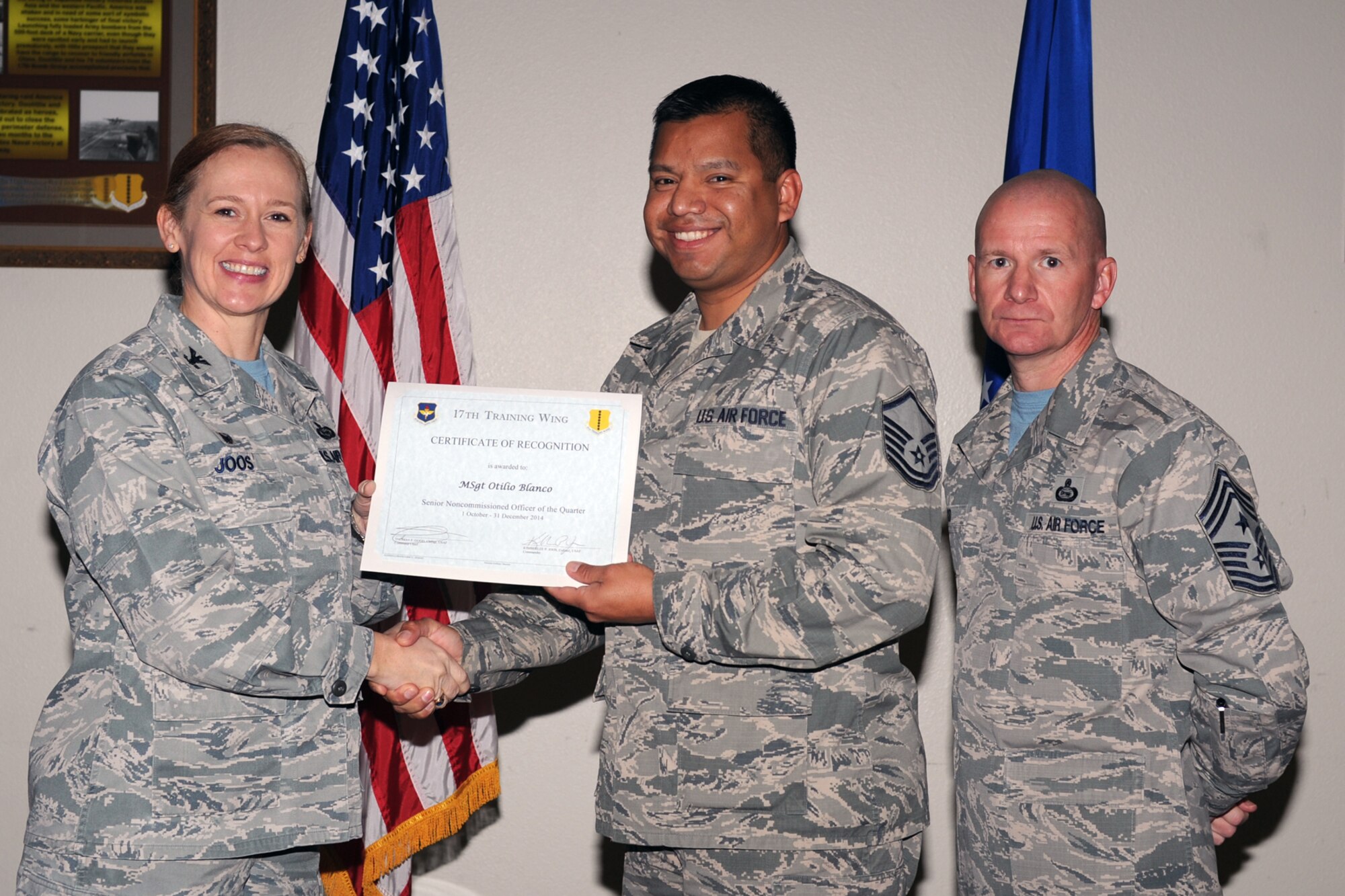 GOODFELLOW AIR FORCE BASE, Texas - Col. Kimberlee P. Joos, 17th Training Wing Commander, and Chief Master Sgt. Thomas F. Good, 17th TRW Command Chief, present the 17th Training Wing Senior NCO of the Quarter award to Master Sgt. Otilio Blanco, 17th Medical Operations Squadron, during the wing quarterly awards ceremony at the Event Center Jan. 16. (U.S. Air Force photo/Staff Sgt. Laura R. McFarlane)