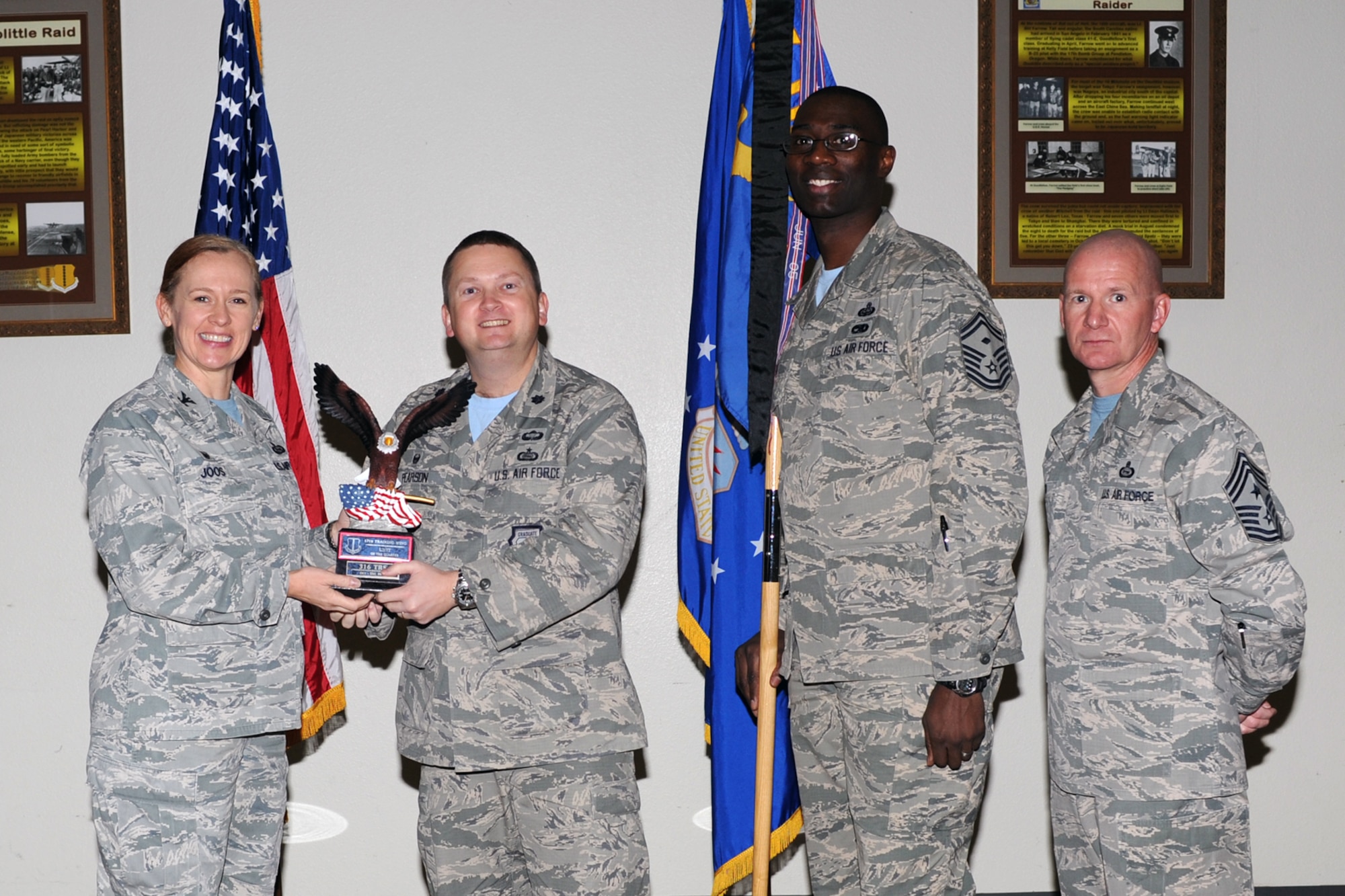 GOODFELLOW AIR FORCE BASE, Texas - Col. Kimberlee P. Joos, 17th Training Wing Commander, and Chief Master Sgt. Thomas F. Good, 17th TRW Command Chief, present the 17th Training Wing Unit of the Quarter award to Lt. Col. Max E. Pearson, 316th Training Squadron Commander, and Senior Master Sgt. Hamp Lee III, 316th TRS first sergeant, during the wing quarterly awards ceremony at the Event Center Jan. 16. (U.S. Air Force photo/Staff Sgt. Laura R. McFarlane)