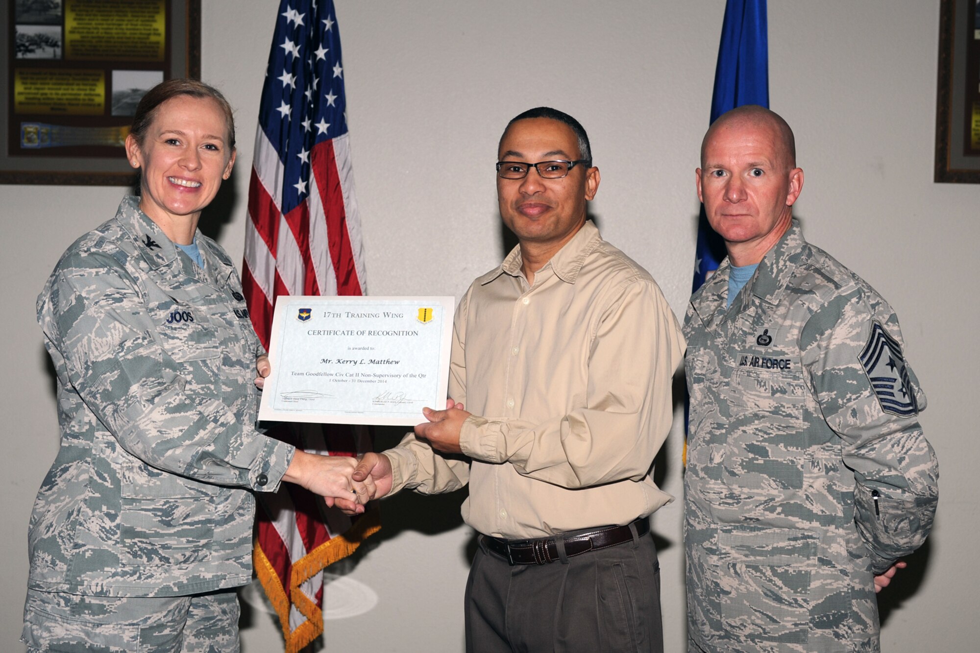 GOODFELLOW AIR FORCE BASE, Texas - Col. Kimberlee P. Joos, 17th Training Wing Commander, and Chief Master Sgt. Thomas F. Good, 17th TRW Command Chief, present the Team Goodfellow Civilian Category II Non-supervisory of the Quarter award to Kerry Matthew, 344th Military Intelligence Battalion, during the wing quarterly awards ceremony at the Event Center Jan. 16. (U.S. Air Force photo/ Staff Sgt. Laura R. McFarlane)