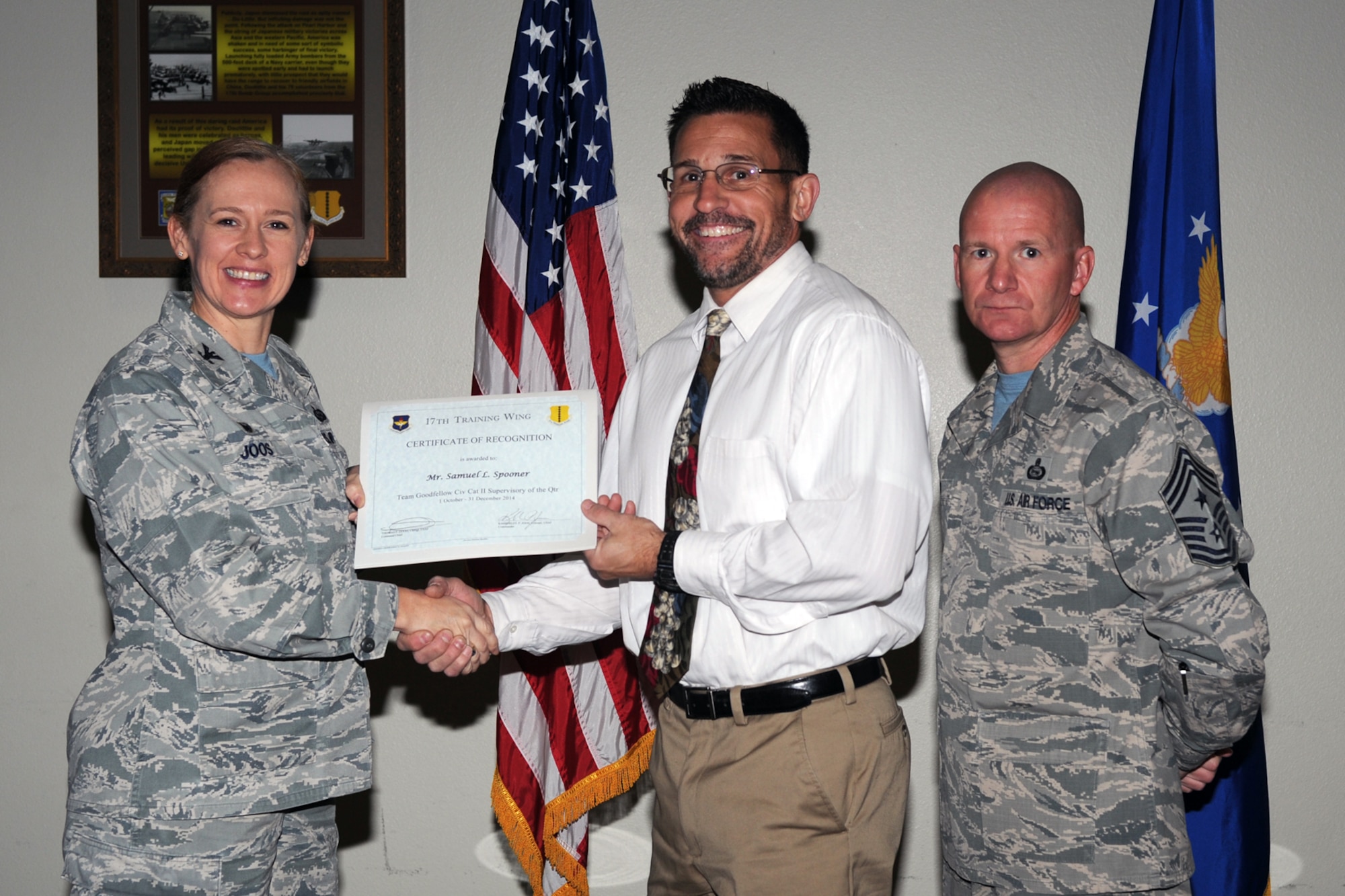 GOODFELLOW AIR FORCE BASE, Texas - Col. Kimberlee P. Joos, 17th Training Wing Commander, and Chief Master Sgt. Thomas F. Good, 17th TRW Command Chief, present the 17th Training Wing Civilian Category II Supervisory of the Quarter award to Samuel L. Spooner, 17th Training Wing Safety Chief, during the wing quarterly awards ceremony at the Event Center Jan. 16. (U.S. Air Force photo/ Staff Sgt. Laura R. McFarlane)