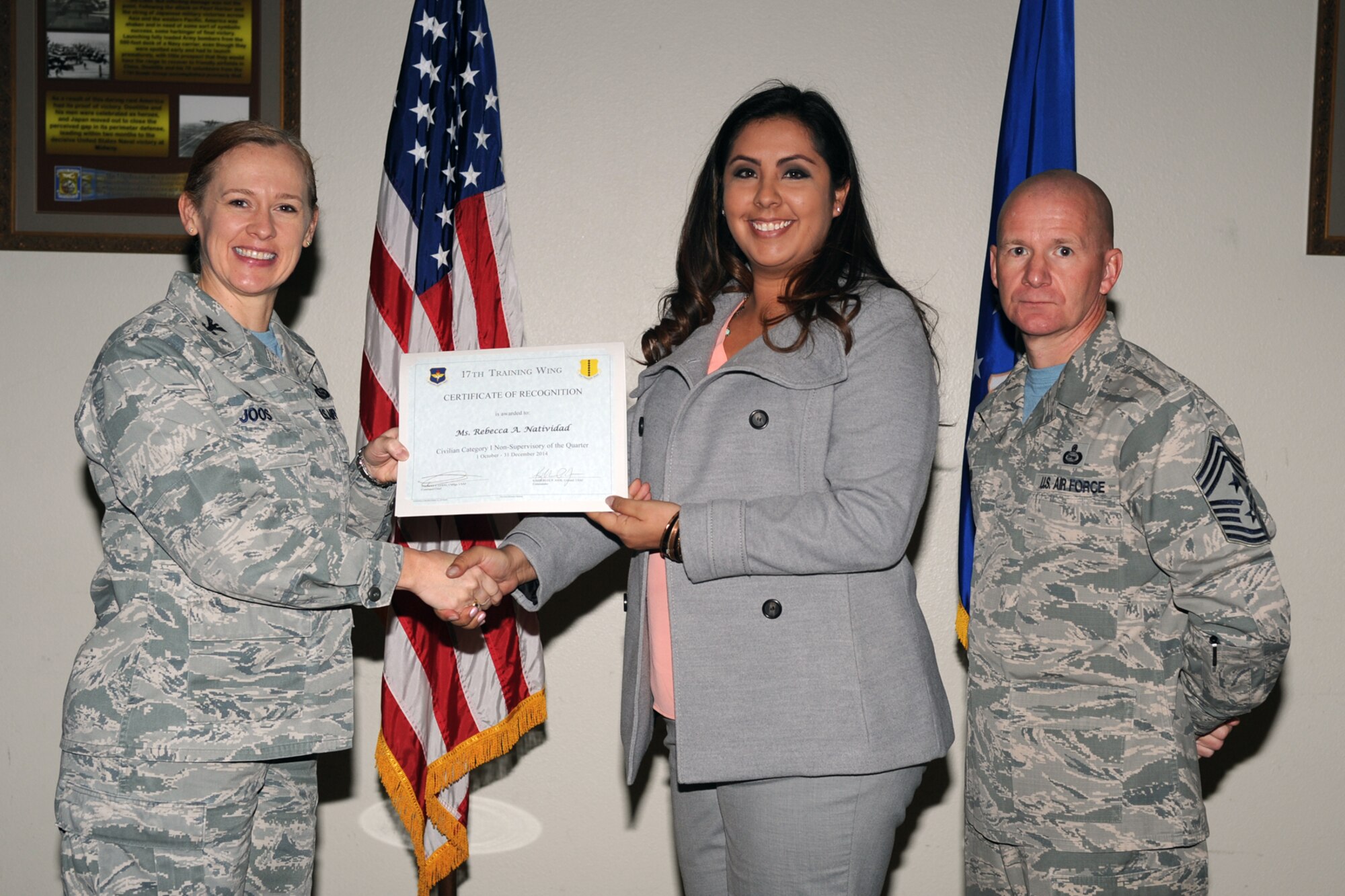 GOODFELLOW AIR FORCE BASE, Texas - Col. Kimberlee P. Joos, 17th Training Wing Commander, and Chief Master Sgt. Thomas F. Good, 17th TRW Command Chief, present the 17th Training Wing Civilian Category I Non-supervisory of the Quarter award to Rebecca A. Natividad, 17th Logistics Readiness Squadron, during the wing quarterly awards ceremony at the Event Center Jan. 16. Natividad also received the Team Goodfellow Civilian Category I (Non-supervisory) of the Quarter. (U.S. Air Force photo/Staff Sgt. Laura R. McFarlane)