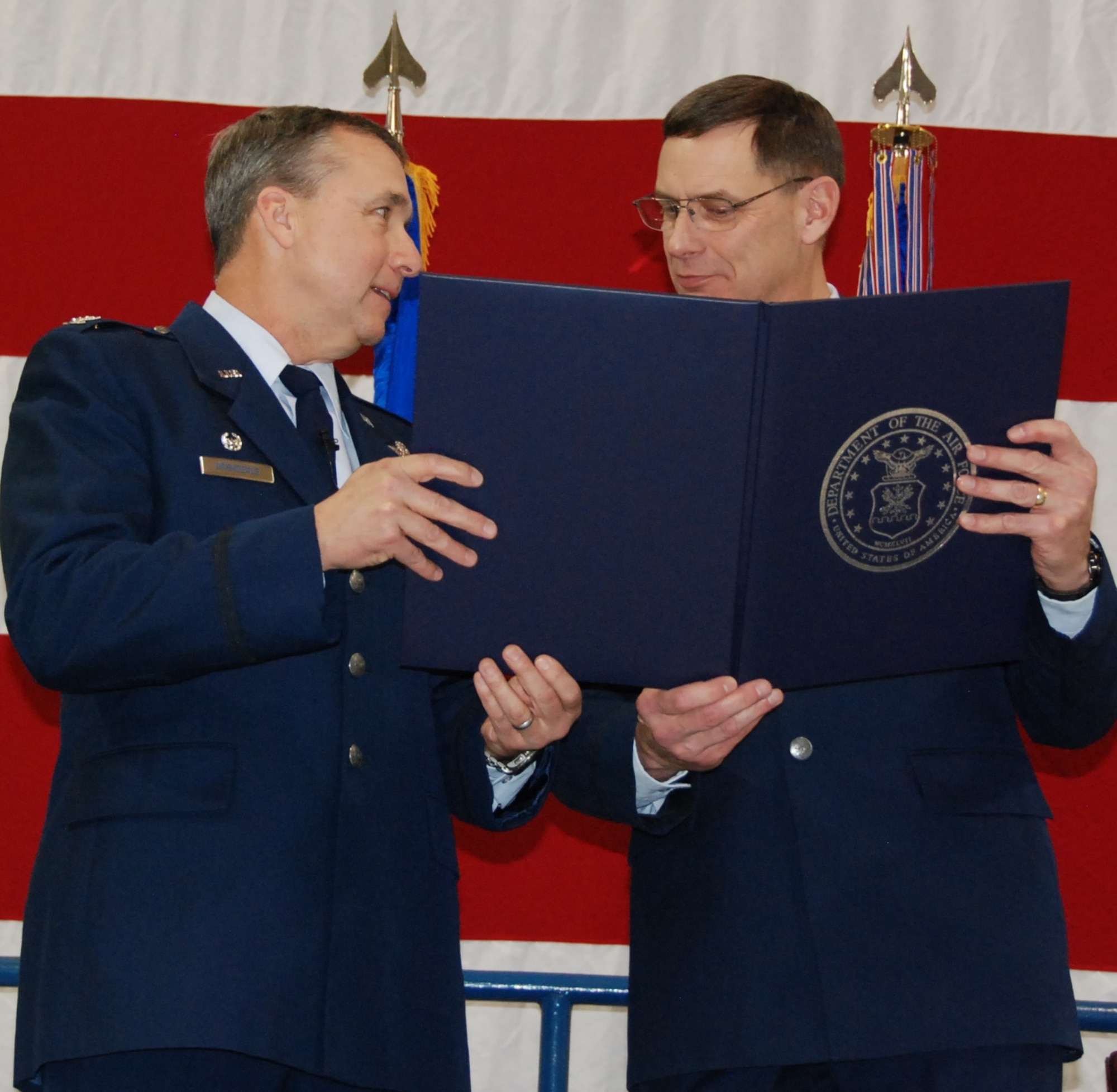 NAVAL AIR STATION FORT WORTH JOINT RESERVE BASE, Texas - Col. John Breazeale (left), 301st Fighter Wing commander, and Col. James Van Housen (right), 301st Maintenance Group commander, hold the retirement certificate that recognizes Van Housen's 33 years of military service during a ceremony here Jan. 11. Recognition of members who are retiring from a career of long, faithful, and honorable service is one of the oldest traditions of military service.(U.S. Air Force photo/Staff Sgt. Melissa Harvey)