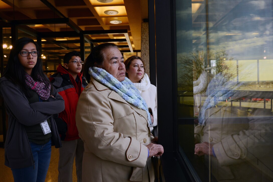 Family members of U.S. Air Force Tech. Sgt. Roberto Ruiz, 7th Civil Engineer Squadron, watch him boarding an airplane Jan. 8, 2015, at the Abilene Regional Airport in Abilene, Texas. Several family members of more than 30 Dyess personnel spent time with their Airmen before they boarded a plane bound for deployment.  (U.S. Air Force photo by Airman 1st Class Kedesha Pennant/Released)