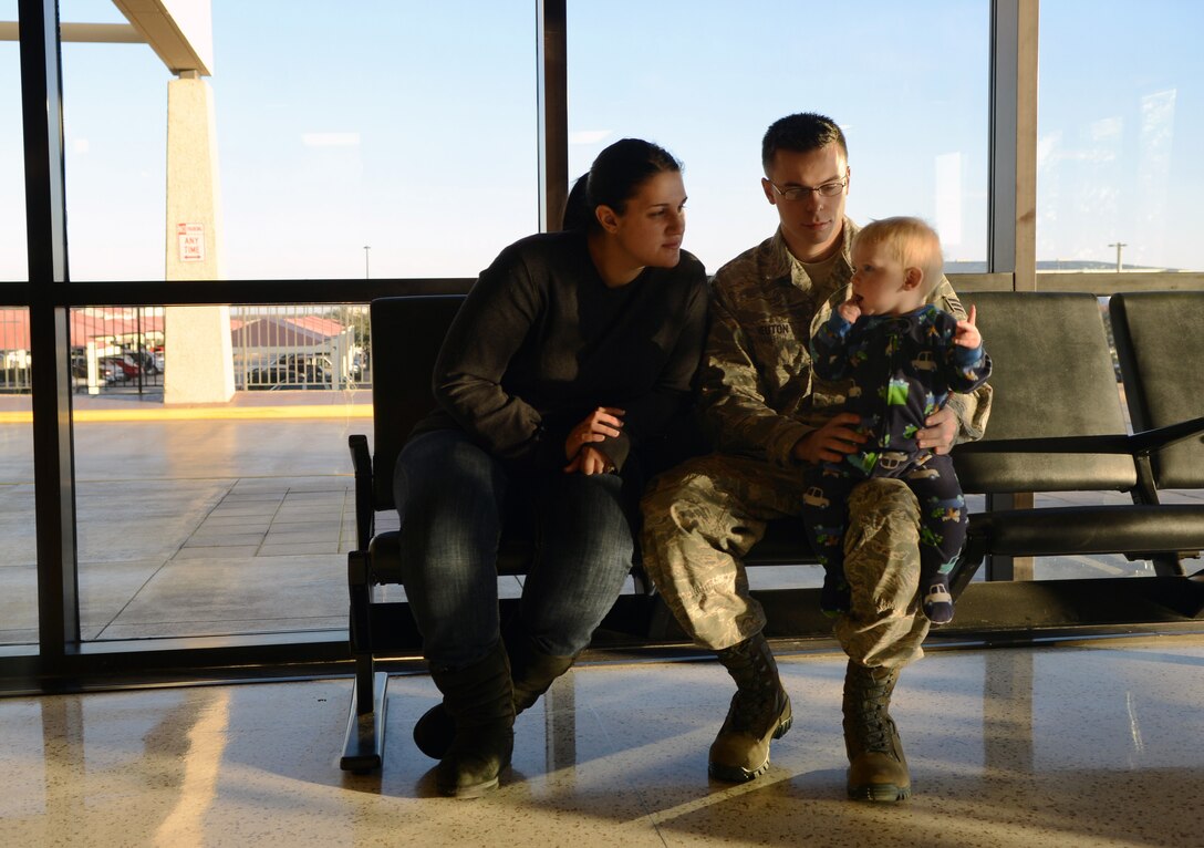 U.S. Air Force Senior Airman Jonathan Heuton, 7th Civil Engineer Squadron heating, ventilation and air conditioning technician, his wife, Kayla, and son, Jace, spend time at the Abilene Regional Airport Jan. 8, 2015, in Abilene, Texas. Heuton and other Dyess Airmen were tasked to deploy in support of U.S. military operations around the globe. (U.S. Air Force photo by Airman 1st Class Kedesha Pennant/Released)