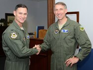 Col. Brett Clark, commander of the 94th Airlift Wing, welcomes Col. Mike Tyynismaa to Dobbins Air Reserve Base, Ga. and the 94th Airlift Wing Jan. 13, 2015. Tyynismaa is the new Civil Air Patrol-USAF commander, headquartered at Maxwell Air Force Base, Ala. and is visiting Lt. Col. Scott D’Antoni, commander of the CAP Southeast Liaison Region office,  at Dobbins.(U.S. Air Force photo/Brad Fallin)