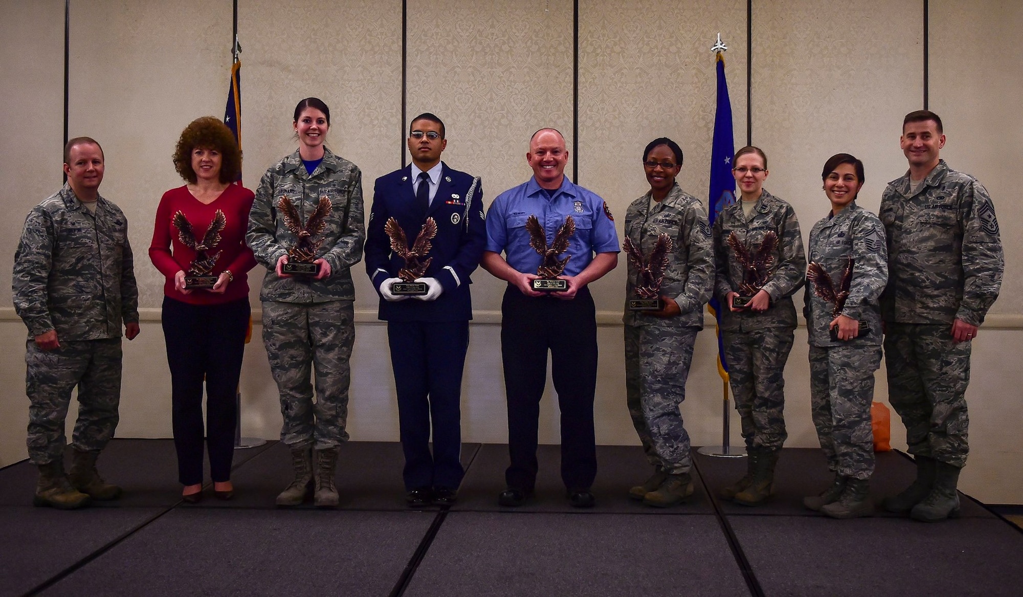 Col. Jeffrey DeVore, Joint Base Charleston commander and Chief Master Sgt. Mark Bronson, 628th Air Base Wing command chief recognize members of the 628th ABW during the Quarterly Awards Ceremony Jan. 16, 2015 at the Charleston Club on Joint Base Charleston, S.C. Winners are (from left) Bettina Roberson, 628th Civil Engineer Squadron (Civilian Category II); Senior Airman Hannah Leonard, 628th Aerospace Medicine Squadron (Airman of the Quarter); Senior Airman Micah Wells, 437th Aircraft Maintenance Squadron (JB Charleston Honor Guard member of the Quarter); William Scott, 628th CES (Civilian Category II); Tech. Sgt. Tamika Jackson, 628th Contracting Squadron (NCO of the Quarter); Capt. Ekaterina Korulina, 628th ABW Legal Office (Company Grade Officer); and Senior Master Sgt. Jakelyne Rose, 628th Comptroller Squadron (SNCO of the Quarter). (U.S. Air Force photo/Senior Airman Dennis Sloan)
