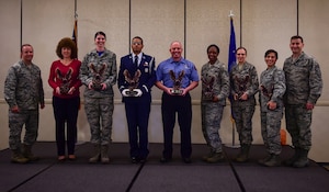 Col. Jeffrey DeVore, Joint Base Charleston commander and Chief Master Sgt. Mark Bronson, 628th Air Base Wing command chief recognize members of the 628th ABW during the Quarterly Awards Ceremony Jan. 16, 2015 at the Charleston Club on Joint Base Charleston, S.C. Winners are (from left) Bettina Roberson, 628th Civil Engineer Squadron (Civilian Category II); Senior Airman Hannah Leonard, 628th Aerospace Medicine Squadron (Airman of the Quarter); Senior Airman Micah Wells, 437th Aircraft Maintenance Squadron (JB Charleston Honor Guard member of the Quarter); William Scott, 628th CES (Civilian Category II); Tech. Sgt. Tamika Jackson, 628th Contracting Squadron (NCO of the Quarter); Capt. Ekaterina Korulina, 628th ABW Legal Office (Company Grade Officer); and Senior Master Sgt. Jakelyne Rose, 628th Comptroller Squadron (SNCO of the Quarter). (U.S. Air Force photo/Senior Airman Dennis Sloan)