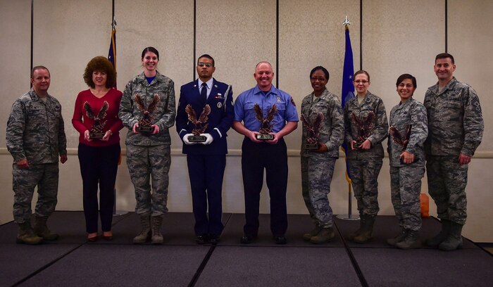 Col. Jeffrey DeVore, Joint Base Charleston commander and Chief Master Sgt. Mark Bronson, 628th Air Base Wing command chief recognize members of the 628th ABW during the Quarterly Awards Ceremony Jan. 16, 2015 at the Charleston Club on Joint Base Charleston, S.C. Winners are (from left) Bettina Roberson, 628th Civil Engineer Squadron (Civilian Category II); Senior Airman Hannah Leonard, 628th Aerospace Medicine Squadron (Airman of the Quarter); Senior Airman Micah Wells, 437th Aircraft Maintenance Squadron (JB Charleston Honor Guard member of the Quarter); William Scott, 628th CES (Civilian Category II); Tech. Sgt. Tamika Jackson, 628th Contracting Squadron (NCO of the Quarter); Capt. Ekaterina Korulina, 628th ABW Legal Office (Company Grade Officer); and Senior Master Sgt. Jakelyne Rose, 628th Comptroller Squadron (SNCO of the Quarter). (U.S. Air Force photo/Senior Airman Dennis Sloan)