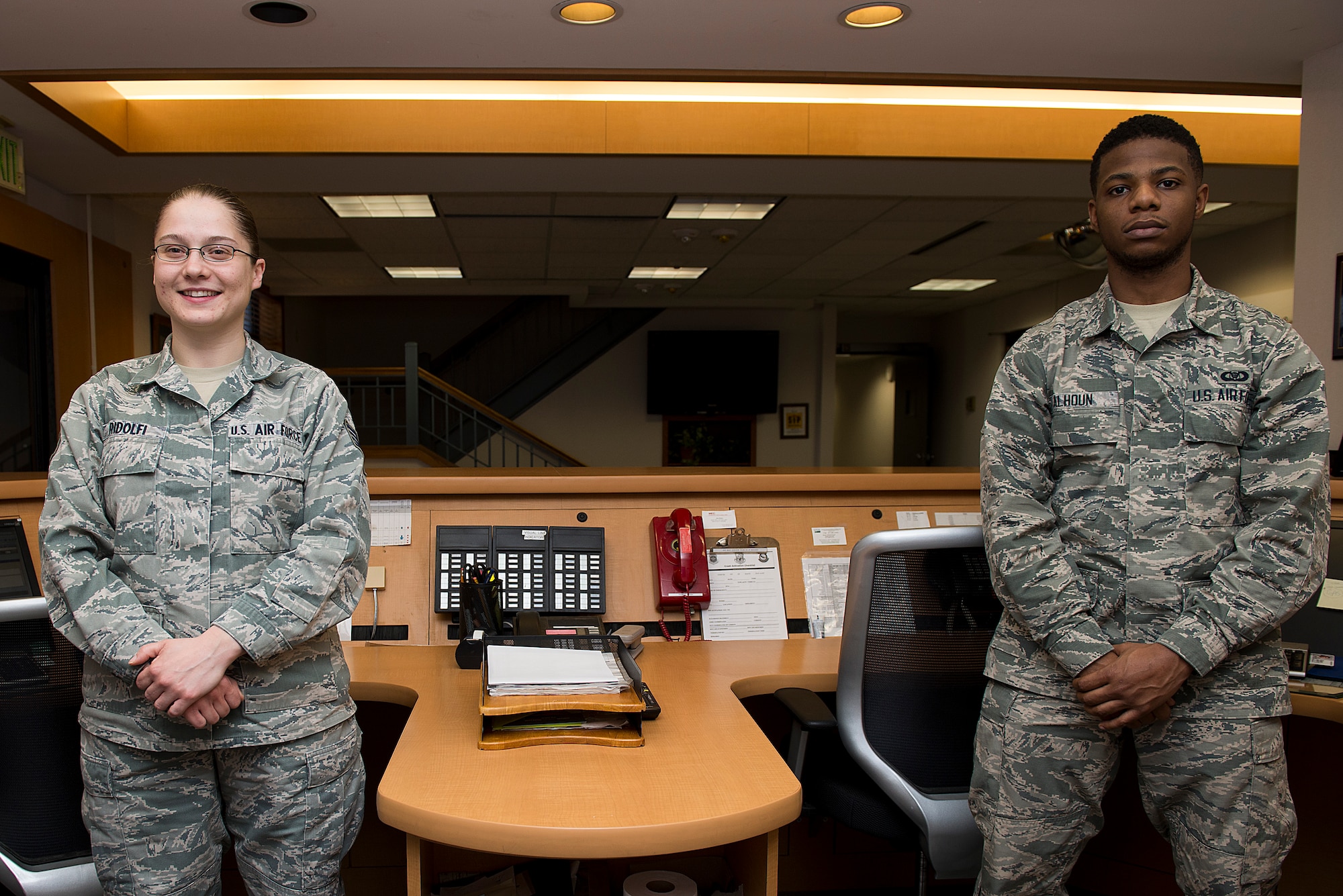 Staff Sgt. Christina Ridolfi, 375 Operation Support Squadron airfield management operations supervisor, and Airman 1st Class Seth Calhoun, 375 OSS airfield management operations coordinator, manage flight services involve filing flight plans for pilots, which states the route the pilot intends on flying, Jan. 16, 2015, at Scott Air Force Base, Ill. The airfield management operations desk conducts airfield checks, report surface conditions of airfield pavement, conduct airfield inspections, process Notice to Airman, brief home station and transient aircrews on airfield status and restrictions, activate the Secondary Crash Phone (SCN) to pass vital emergency information to support agencies, and respond to airfield emergencies. (U.S. Air Force photo/Senior Airman Joshua Eikren)