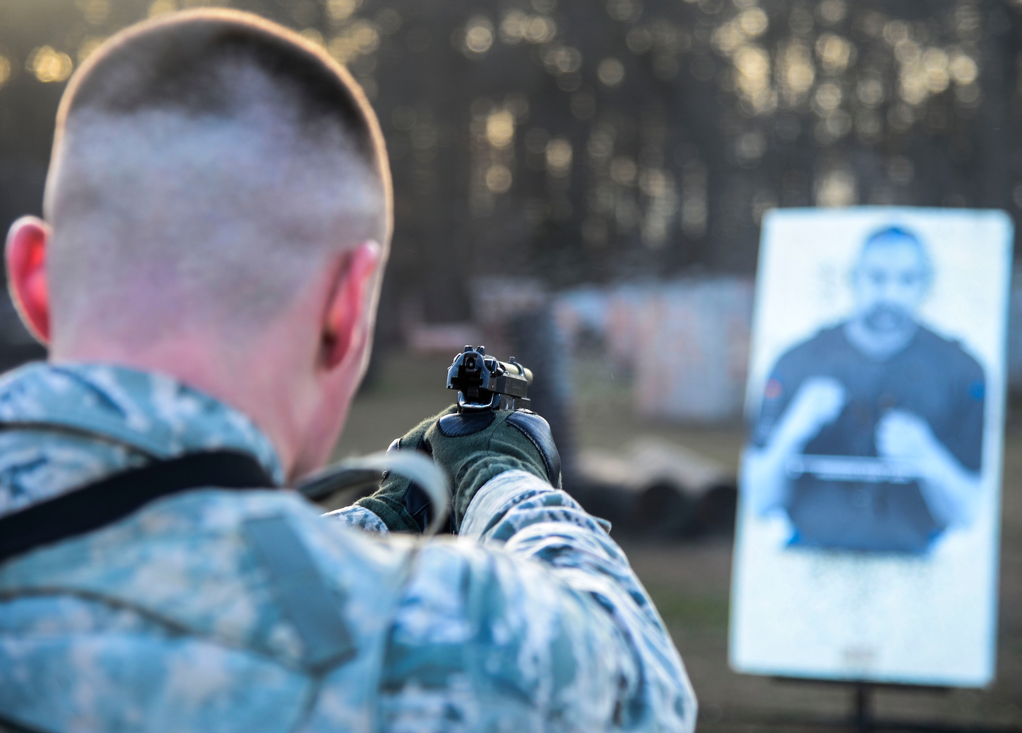 U.S. Air Force Airman 1st Class Michael Viola, 633rd Security Forces Squadron installation entry controller, fires an M-9 pistol at a target during emergency service team tryouts at Langley Air Force Base, Va., Jan. 20, 2015. Viola and other members of SFS ran a timed obstacle course in an effort to qualify to be a part of the specialized team. (U.S. Air Force photo by Senior Airman Kayla Newman/Released) 
