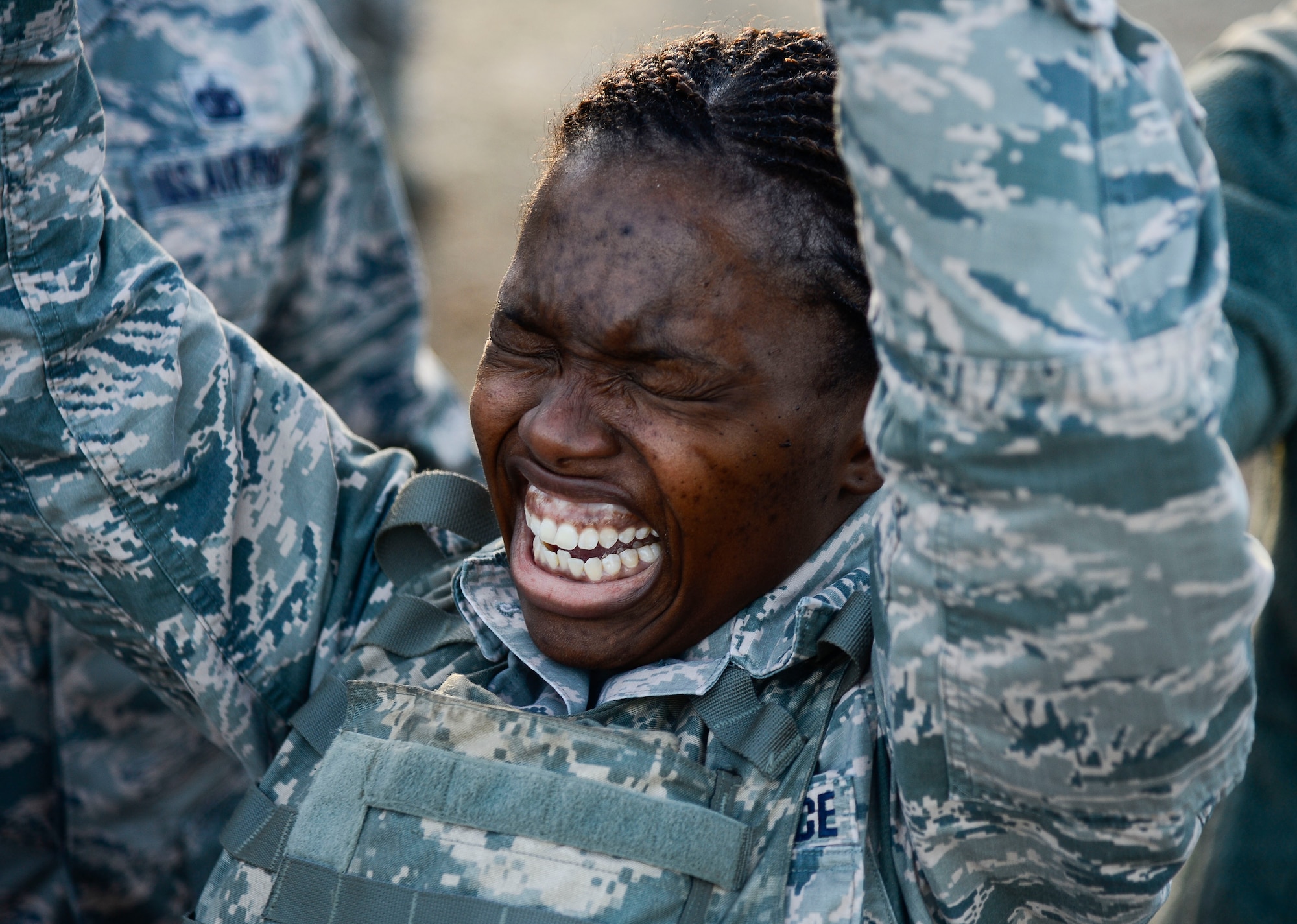 U.S. Air Force Staff Sgt. Joan Morgan, 633rd Security Forces Squadron installation entry controller, presses an ammunition can during emergency service team tryouts at Langley Air Force Base, Va., Jan. 20, 2015. SFS Airmen were required to lift a 30-pound ammunition can above their head a minimum of 50 times as one of the tasks during the tryouts. (U.S. Air Force photo by Senior Airman Kayla Newman/Released) 