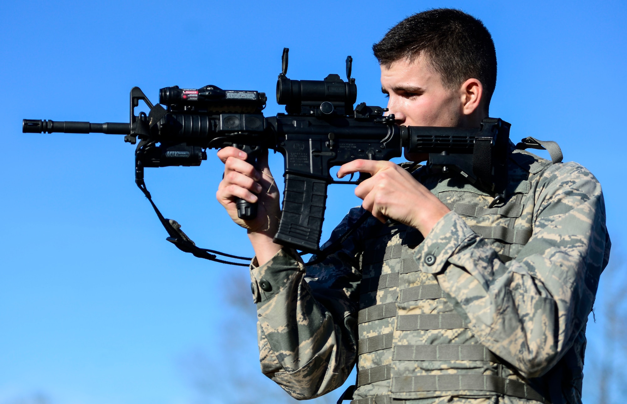 U.S. Air Force Airman Dylan Coady, 633rd Security Forces Squadron installation entry controller, fires paint rounds out of an M-4 carbine during emergency service team tryouts at Langley Air Force Base, Va., Jan. 20, 2015. Air Force EST’s are similar to special weapons and tactics teams as they may be called on to handle high-risk situations on installations. (U.S. Air Force photo by Senior Airman Kayla Newman/Released) 