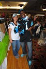 Showing their Carolina Panthers pride, Tech. Sgt. LeMario McPhaul and his wife Yesenia pose for a photo during Super Base Extravaganza Jan. 17, 2015, at the Northern Lights Club on Grand Forks Air Force Base, N.D. The McPhauls were named the first place winners in the Best Dressed Fan competition, couples category. (U.S. Air Force photo/Staff Sgt. Luis Loza Gutierrez)