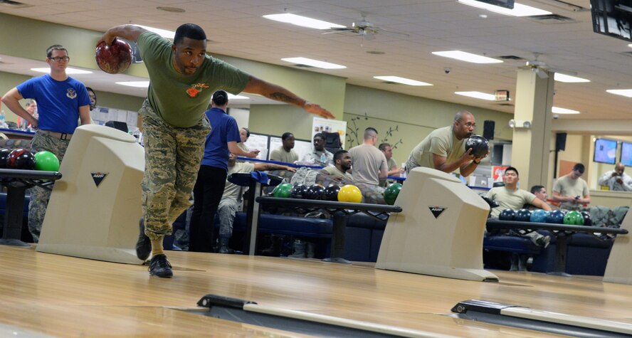 U.S. Air Force Tech. Sgt. Forris Phillips, 23d Civil Engineer Squadron logistics manager, attempts to roll a bowling ball Jan. 16, 2015, at Moody Air Force Base, Ga. Phillips was among many Team Moody members who participated in the Dr. Martin Luther King Jr. bowl-a-thon. (U.S. Air Force photo by Airman Greg Nash/Released)