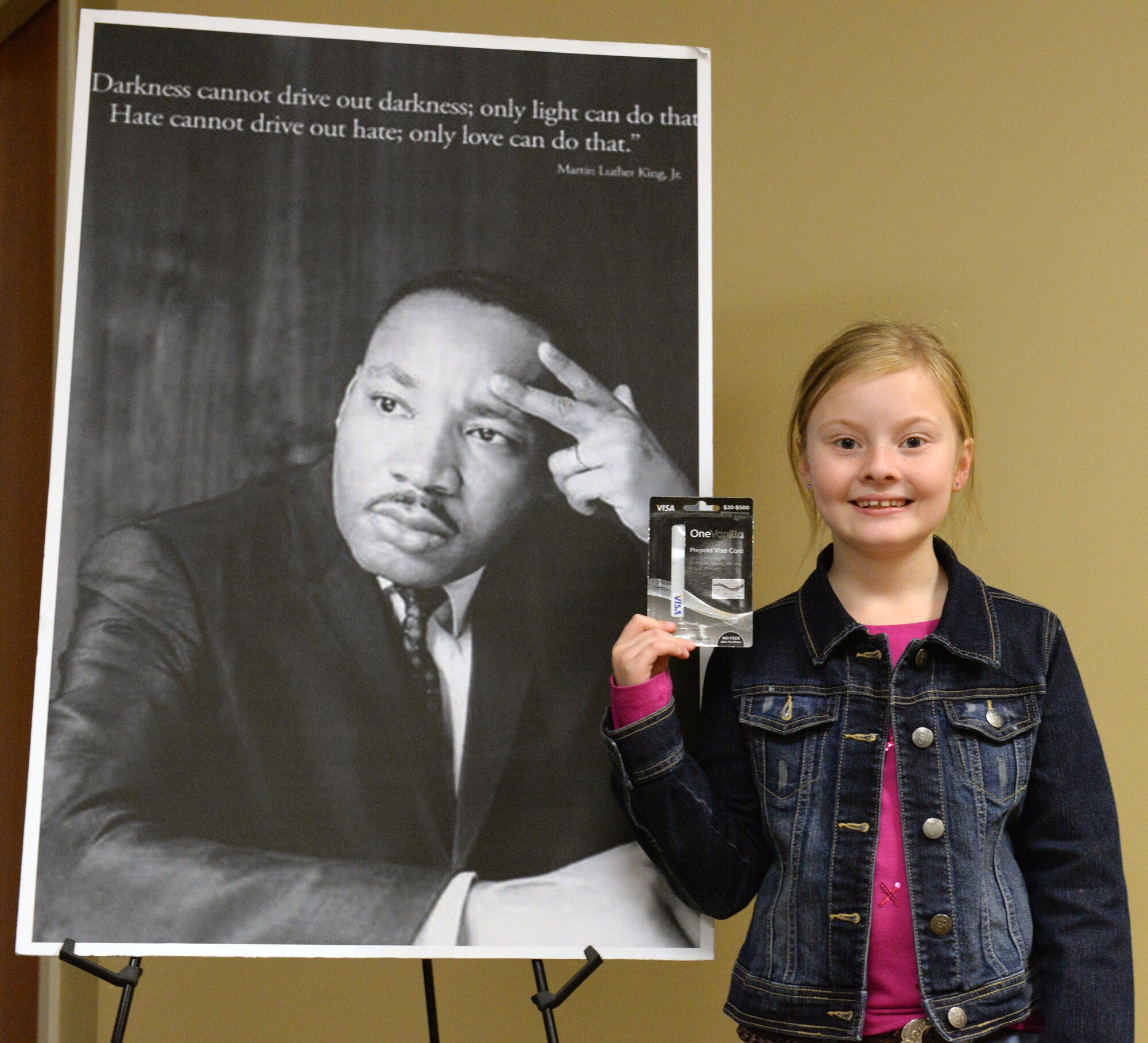 Sydney Hnat, daughter of U.S. Air Force Tech. Sgt. Michelle Hnat, 23d Wing Judge Advocate office NCO in charge of general law, poses for a photo after receiving a gift card Jan. 16, 2015, at Moody Air Force Base, Ga. Sydney received recognition for her speech on why she admires Dr. Martin Luther King Jr. prior to the MLK bowl-a-thon. (U.S. Air Force photo by Airman Greg Nash/Released) 
