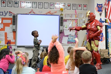 Tech. Sgt. Brian Thornton, 628th Air Base Wing Air Defense Council paralegal, engages with children at Marrington Elementary, Joint Base Charleston - Weapons Station, S.C. while dressed up in his homemade Iron Man suit Dec. 8, 2014. Thornton wears his Iron Man suit at local schools and hospitals hoping to help brighten a child’s day. (U.S. Air Force photo/Senior Airman Christopher Reel)