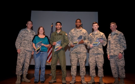 Col. John Lamontagne, 437th Airlift Wing commander, and Chief Master Sgt. Shawn Hughes, 437th AW command chief, recognize members of the 437th AW during the fourth quarter of 2014.  Winners are (from left) Valerie Singley, 17th Airlift Squadron, Capt. Ashish Patel, 14th Airlift Squadron, Tech. Sgt. Chelce Green, 437th Aerial Port Squadron and Airman 1st Class Bradley Jones, 437th Operation Support Squadron. Not pictured: Master Sgt. Charles Hall (Senior Noncommissioned Officer of the Quarter), 437th OSS and Bradley Kirk (Civilian Category II of the Quarter), 437th APS. (U.S. Air Force Photo / Senior Airman Tom Brading)

