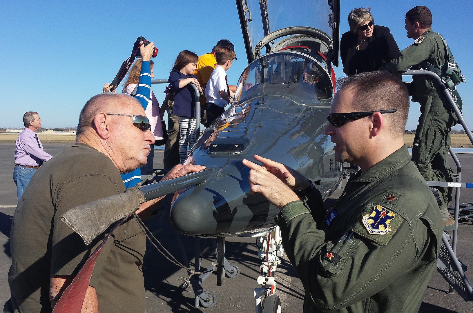 Maj. Robert Lee, 12th Operations Support Squadron, gives a tour of a T-38C Talon to retired Seguin Firefighter Elroy Hoffer during symbolic ribbon cutting event at Joint Base San Antonio-Randolph Seguin Auxiliary Airfield Jan. 20. The event signified the reopening of the airfield following a $12.4 million repaving and construction project that included replacing and grading the entire airfield, stabilizing existing soils, and constructing a new taxiway, parking apron and emergency access road.  (U.S. Air Force photo by Johnny Saldivar)