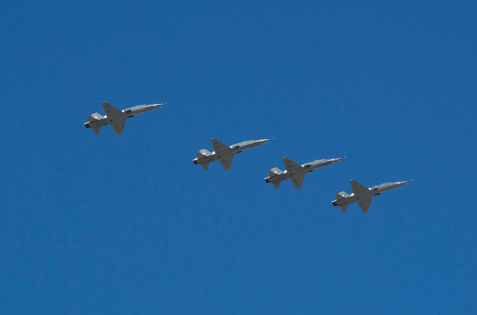 A formation of T-38C Talons flies over Joint Base San Antonio-Randolph Seguin Auxiliary Airfield during a ribbon cutting event signifying the reopening of the JBSA-Randolph Seguin Auxiliary Airfield Jan. 20.  Upon completion of a three-year construction project, the airfield is now ready for flying by members of the 560th Flying Training Squadron.  The airfield is crucial for “touch and go” training that qualifies fighter and bomber pilots as instructor pilots in the T-38C Talon.  The reconstructed runway increases flight safety by distributing training around the San Antonio area, which means fewer aircraft and less congestion around Joint Base San Antonio-Randolph. (U.S. Air Force photo by Johnny Saldivar)