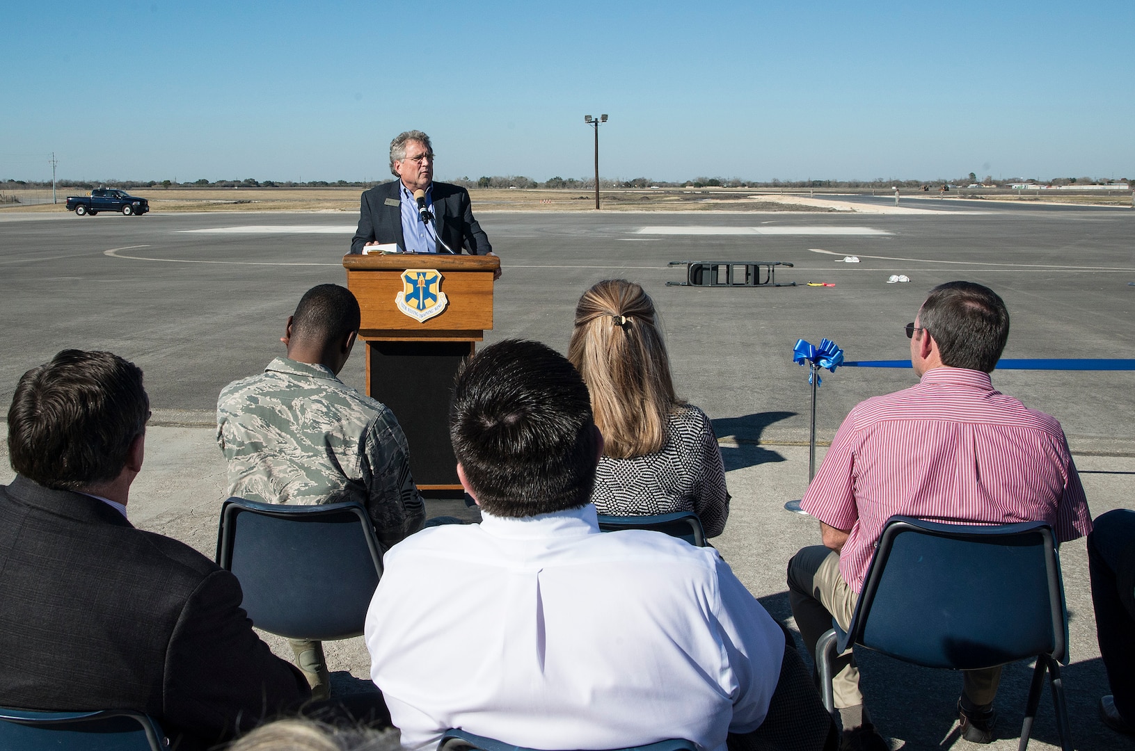 City of Seguin Mayor Don Keil, addresses the crowd during a symbolic ribbon cutting event at Joint Base San Antonio-Randolph Seguin Auxiliary Airfield Jan. 20. The event signified the reopening of the airfield following a $12.4 million repaving and construction project that included replacing and grading the entire airfield, stabilizing existing soils, and constructing a new taxiway, parking apron and emergency access road.  (U.S. Air Force photo by Johnny Saldivar)