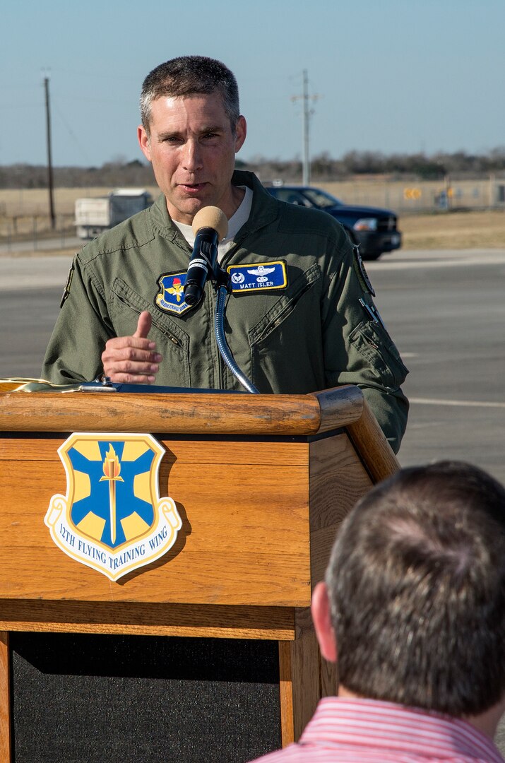 Col. Matt Isler, 12th Flying Training Wing commander, addresses the crowd during the symbolic ribbon cutting event at Joint Base San Antonio-Randolph Seguin Auxiliary Airfield Jan. 20. The event signified the reopening of the airfield following a $12.4 million repaving and construction project that included replacing and grading the entire airfield, stabilizing existing soils, and constructing a new taxiway, parking apron and emergency access road.  (U.S. Air Force photo by Johnny Saldivar)