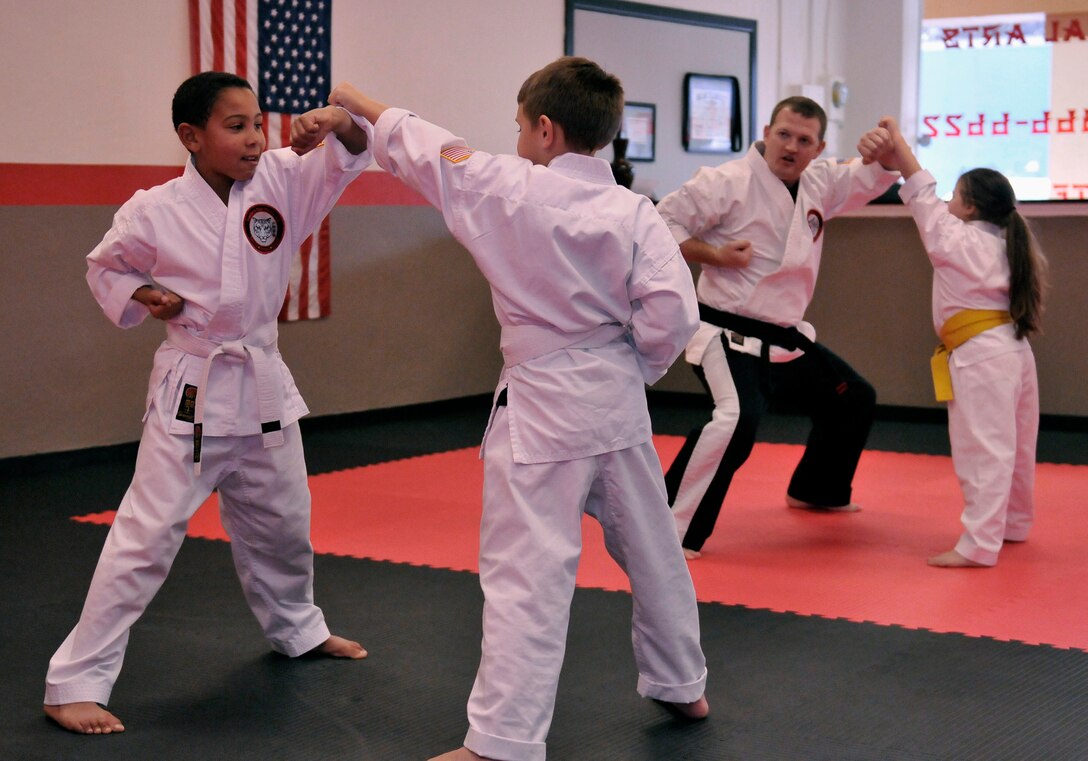 Staff Sgt. Chris Cowgill, a command post controller for the 125th Fighter Wing, leads a children's Shoalin Kempo class Jan. 9, at his studio in Orange Park, Florida. Cowgill opened the studio with his wife and business partner, and he teaches Shoalin Kempo to students of all ages during his off-duty days. (U.S. Air National Guard photo by Tech. Sgt. William Buchanan/ Released)
 