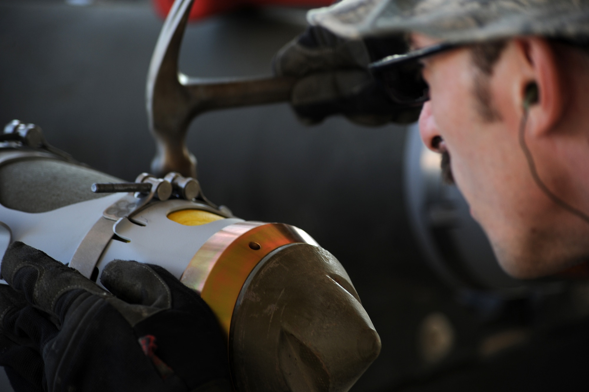 Staff Sgt. John secures a strake strap onto an MK-82 munition Dec. 21, 2014, in Southwest Asia. The strap ensures the munition is lined up properly on the aircraft racks. John is a conventional crew chief and is deployed from Seymour Johnson Air Force Base, N.C. (U.S. Air Force photo/Senior Master Sgt. Carrie Hinson)
