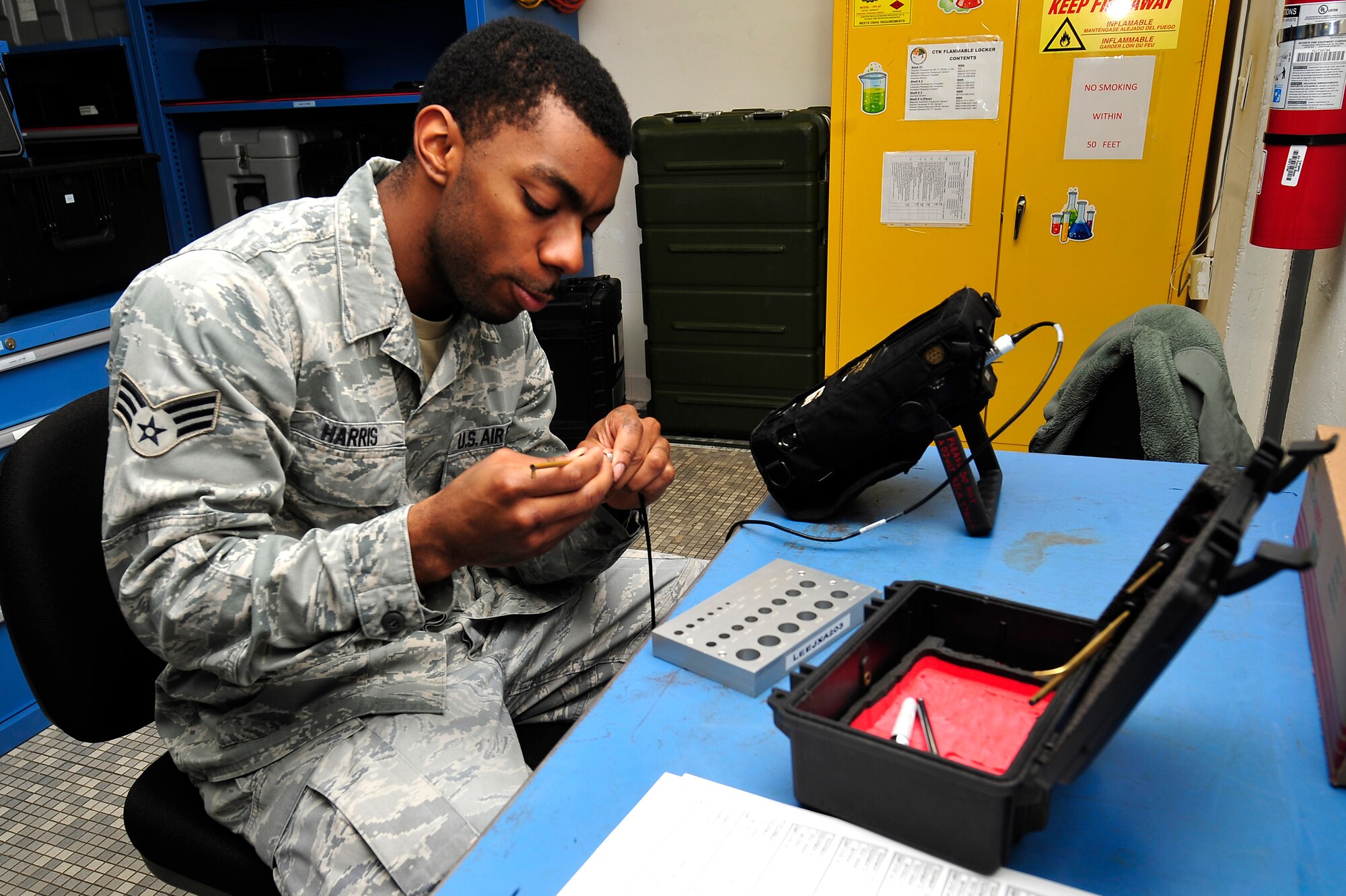 U.S. Air Force Senior Airman Kellyn Harris, 1st Maintenance Squadron non-destructive inspection journeyman, uses an eddy current kit at Langley Air Force Base, Va., Jan. 21, 2015. The eddy current kit is used to check for cracks on steel, aluminum and titanium parts. (U.S. Air Force photo by Airman 1st Class Breonna Veal/Released)