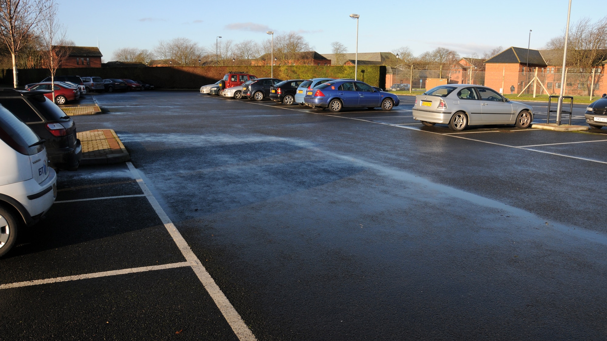 The 100th Logistics Readiness Squadron deployment and distribution flight utilizes the previous auto resale lot parking lot for their employees Jan. 13, 2015, on RAF Mildenhall, England. With the expansion of use of building 582 came the increased number of personnel, so more parking was needed. (U.S. Air Force photo by Gina Randall/Released)
