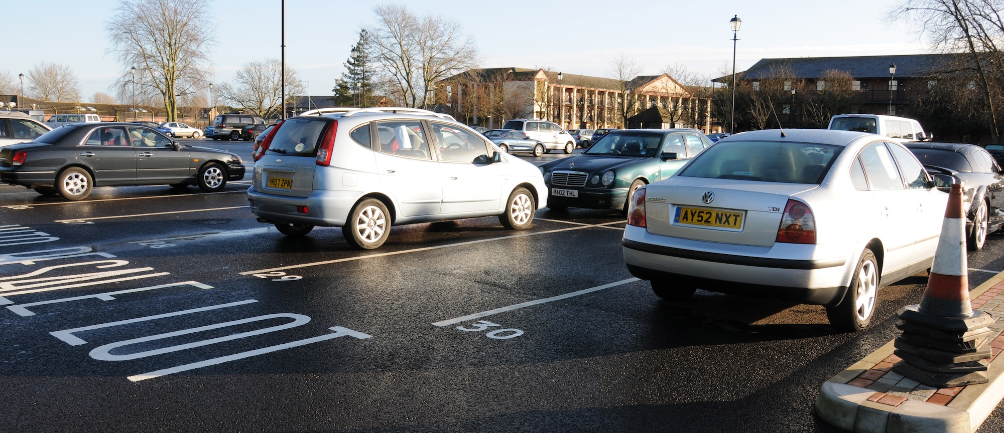 Vehicles sit in allotted spaces in the new auto resale lot Jan. 13, 2015, on RAF Mildenhall, England. Authorized vehicles can be parked in any numbered parking space proving the owner pays $15 per calendar month to do so. (U.S. Air Force photo illustration by Gina Randall/Released)