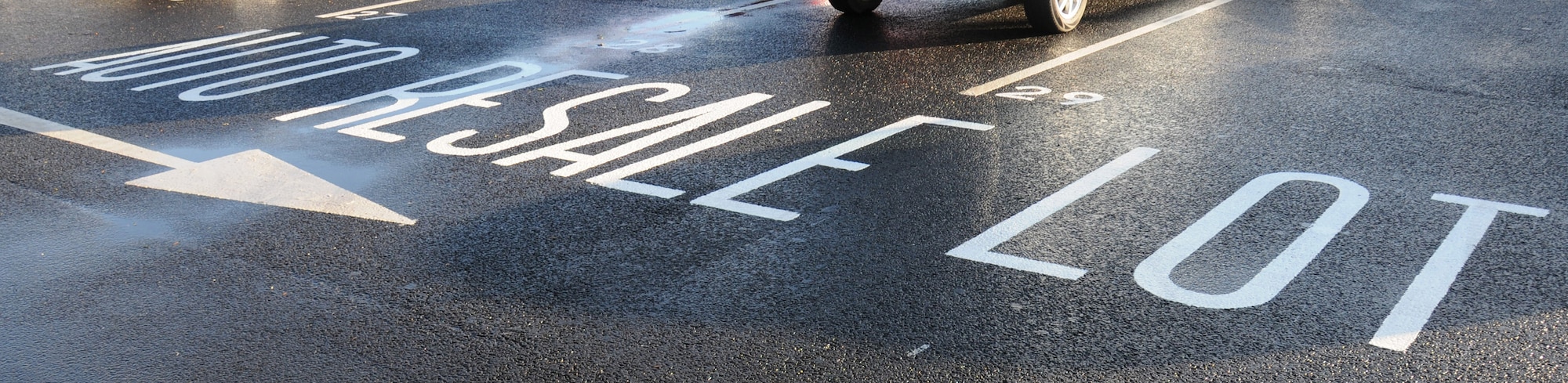 Road markings allow users to clearly see where the resale lot spaces are located Jan. 13, 2015, on RAF Mildenhall, England. The 100th Force Support Squadron Bob Hope Community Center auto resale lot has recently moved location to the laundromat parking lot. (U.S. Air Force photo by Gina Randall/Released)