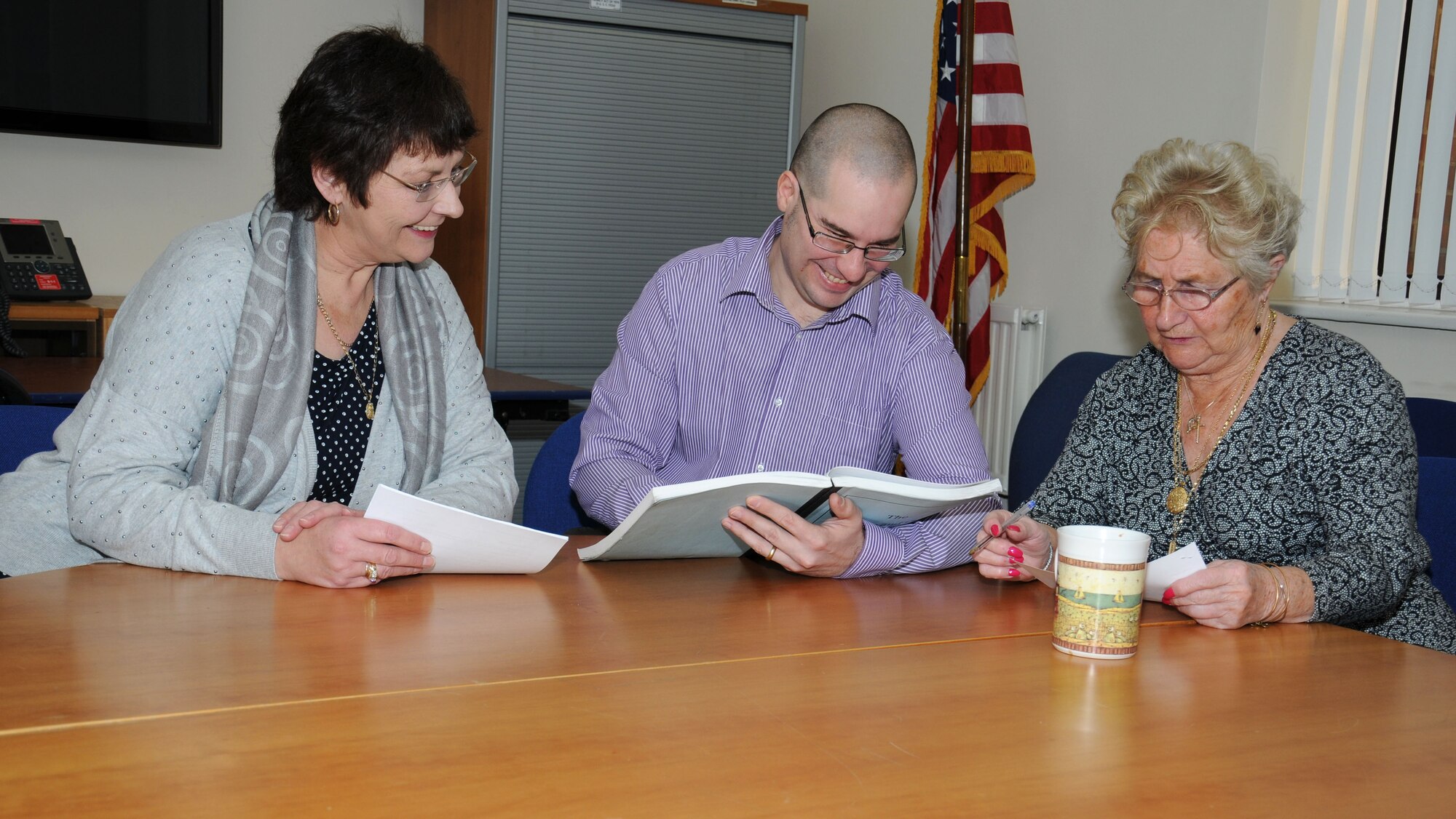 Left to right, Michele Hortenstine, 100th Force Support Squadron Civilian Personnel Office United Kingdom liaison officer from Sheffield, England; Richard Ribardo, 100th FSS CPO human resources specialist from Lakenheath, Suffolk; and Patricia Hall, 100th FSS CPO advisor to the civilian personnel officer from Feltwell, Norfolk, meet to discuss policies Dec. 31, 2014, on RAF Mildenhall, England. The office recently won the USAFE-AFAFRICA CPO of the Year award. (U.S. Air Force photo by Gina Randall/Released)