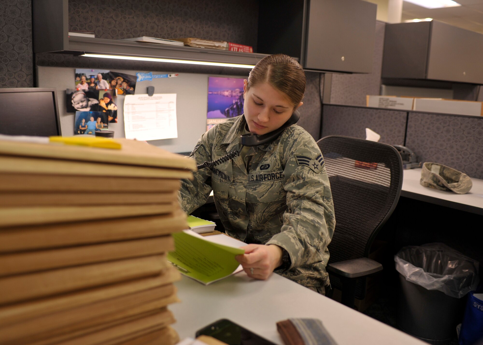 Senior Airman Naomi Haney, 92nd Contracting Squadron contracting specialist, assists a customer and looks at their file Jan. 12, 2015, at Fairchild Air Force Base, Wash. Haney’s leadership selected her as one of Fairchild’s Finest, a weekly recognition program that highlights top-performing Airmen. (U.S. Air Force photo/Airman 1st Class Taylor Bourgeous)