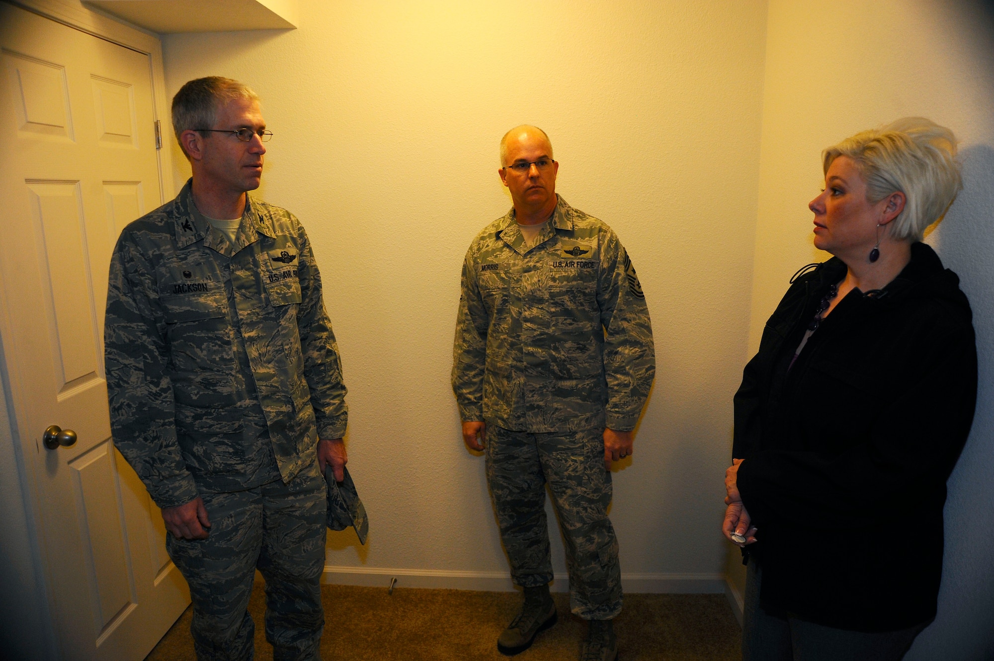 Col. Joel Jackson, 22nd Air Refueling Wing commander, and Chief Master Sgt. Michael Morris, 22nd ARW command chief, listen to Brandy VanVickle, Corvias Military Living community manager, as she describes renovations being made to homes in base housing, Jan. 20, 2015, at McConnell Air Force Base, Kan. Corvias will renovate more than 200 homes built in the 1990s with new living space in basements, new flooring, fixtures, paint and appliances over the next several months. (U.S. Air Force photo/Senior Airman Victor J. Caputo)