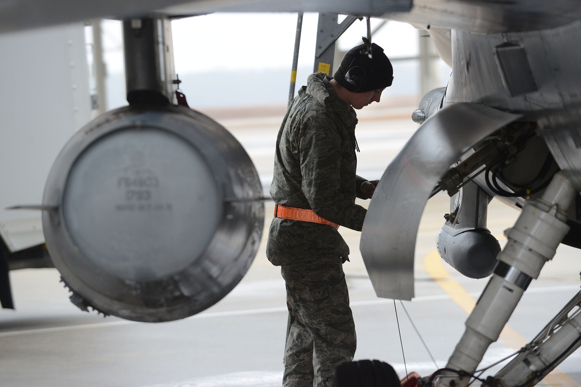 A U.S. Air Force Airman assigned to the 20th Aircraft Maintenance Squadron inspects an F-16CM Fighting Falcon during a surge at Shaw Air Force Base, S.C., Jan. 13, 2015. The surge is a five-day increased day and night operation of sorties for Airmen to sustain readiness. (U.S. Air Force photo by Airman 1st Class Diana M. Cossaboom/Released)
