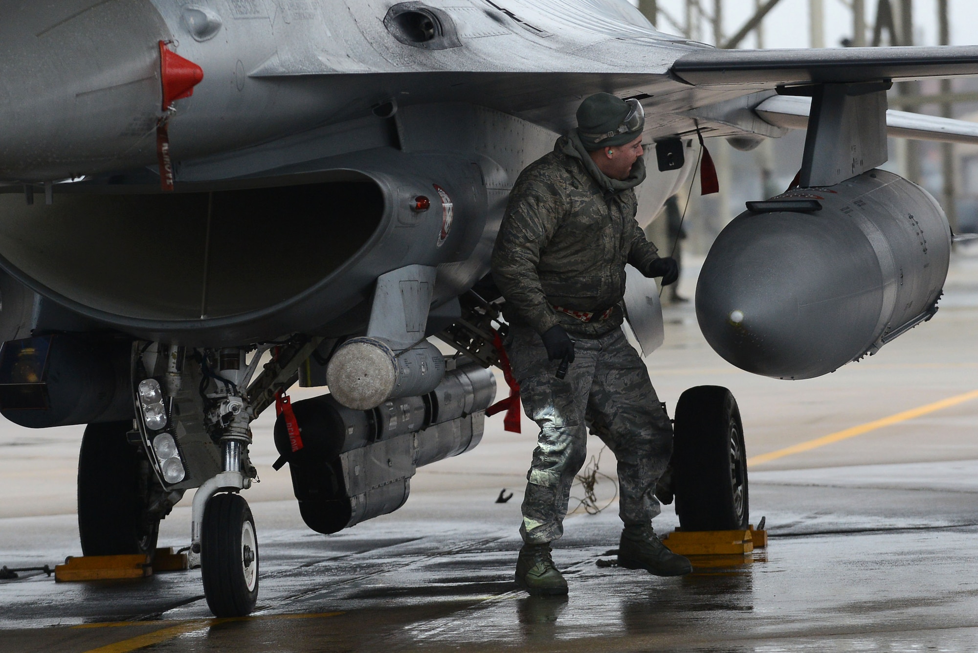 A U.S. Air Force Airman assigned to the 20th Aircraft Maintenance Squadron inspects an F-16CM Fighting Falcon during a surge at Shaw Air Force Base, S.C., Jan. 13, 2015. During the five-day surge, Airmen worked increased day and night operations to maintain readiness. (U.S. Air Force photo by Airman 1st Class Diana M. Cossaboom/Released)