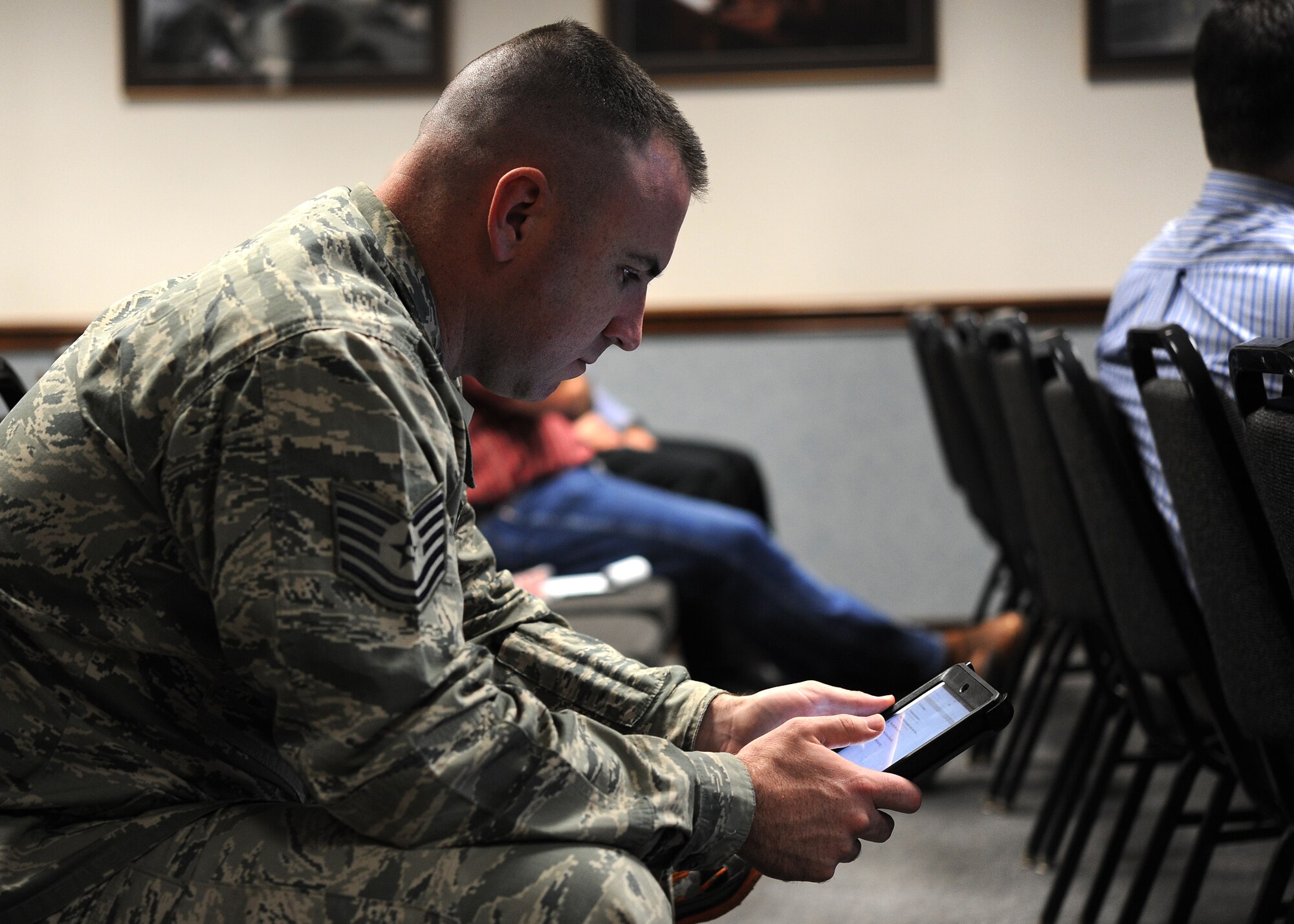 GOODFELLOW AIR FORCE BASE, Texas – Tech. Sgt. Stephen P. Weaver, 312th Training Squadron instructor, examines an Apple iPad mini at the Louis F. Garland Department of Defense Fire Academy during a presentation Jan. 20. The presentation showed the instructors how to use the portable devices and how to access the Block V Hazardous Materials study guide for classroom use. (U.S. Air Force photo/ Airman 1st Class Devin Boyer)