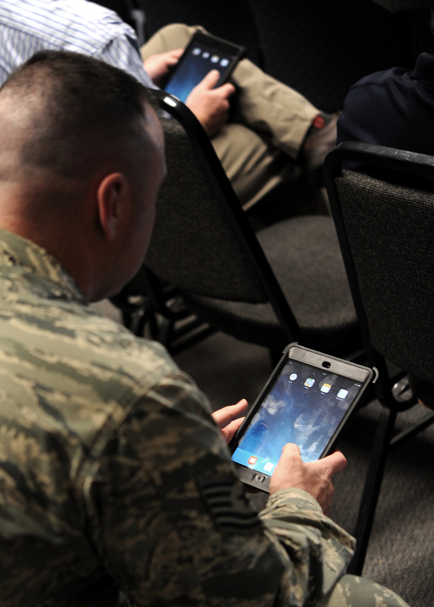 GOODFELLOW AIR FORCE BASE, Texas – Tech. Sgt. Stephen P. Weaver, 312th Training Squadron instructor, examines an Apple iPad mini at the Louis F. Garland Department of Defense Fire Academy during a presentation Jan. 20. The presentation showed the instructors how to use the portable devices and how to access the Block V Hazardous Materials study guide for classroom use. (U.S. Air Force photo/ Airman 1st Class Devin Boyer)